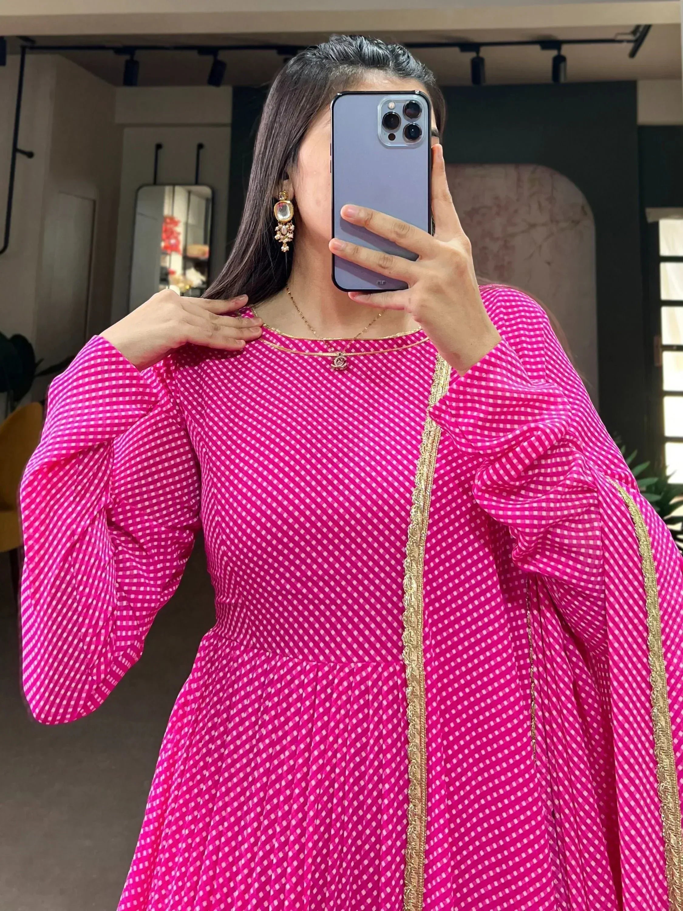 Pink checkered ethnic gown with gold trim, puffed sleeves, and mirror selfie