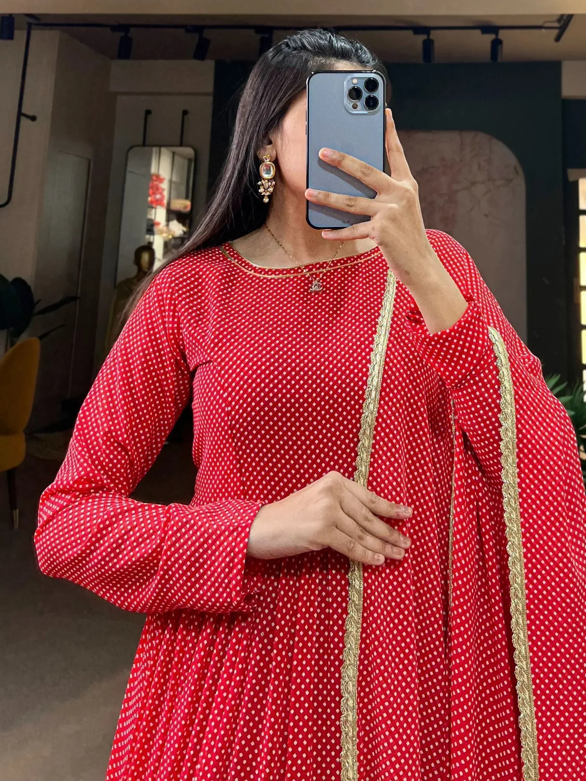 Red printed ethnic gown with gold trim, perfect for Indian festive wear and occasions