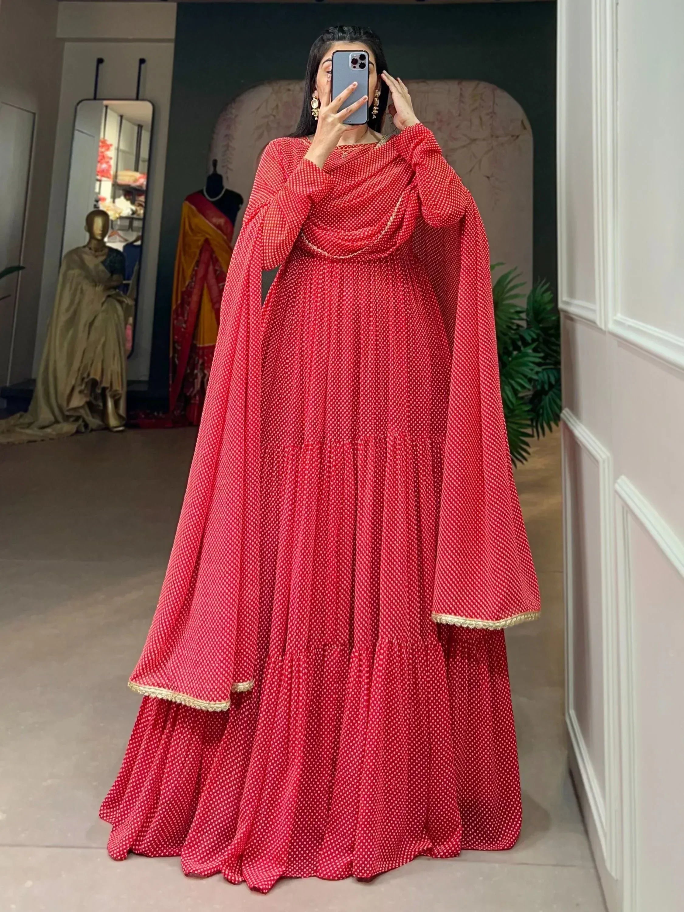 Red polka dot ethnic gown with gold trim, perfect for Indian occasions and festive wear