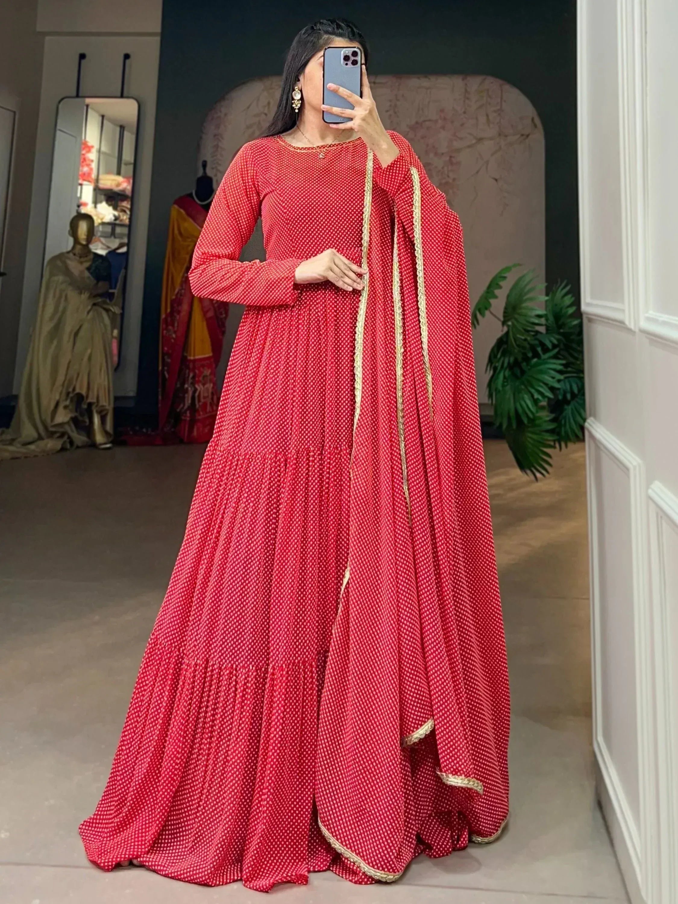 Red polka dot ethnic gown with gold trim, perfect for Indian festive occasions and weddings