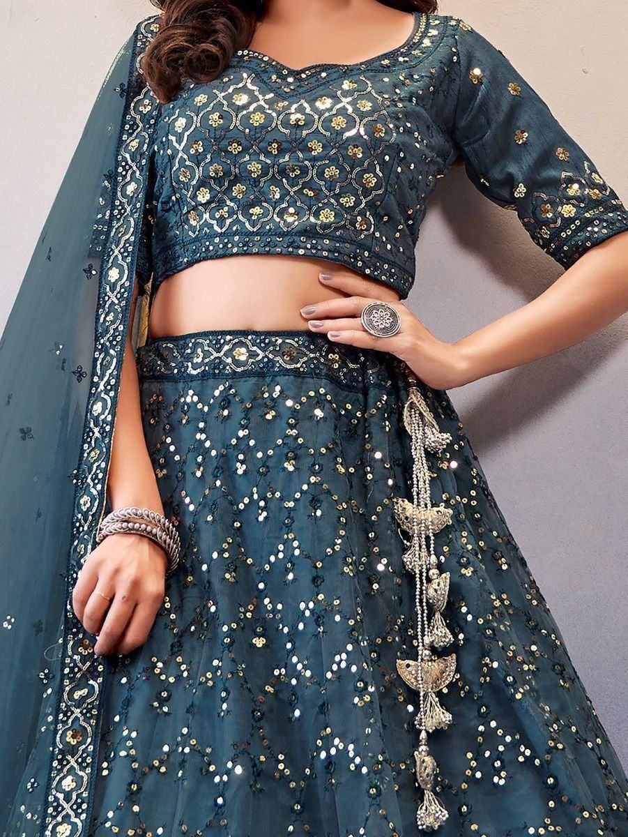 Teal blue designer lehenga choli with gold embroidery, sequins, and tassel details for Indian ethnic wear