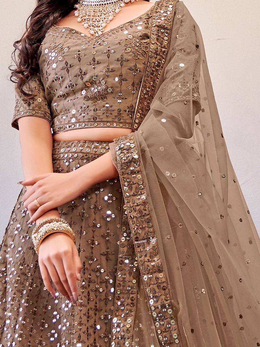 Elegant brown lehenga choli with mirror work and sheer dupatta, perfect for Indian ethnic occasions