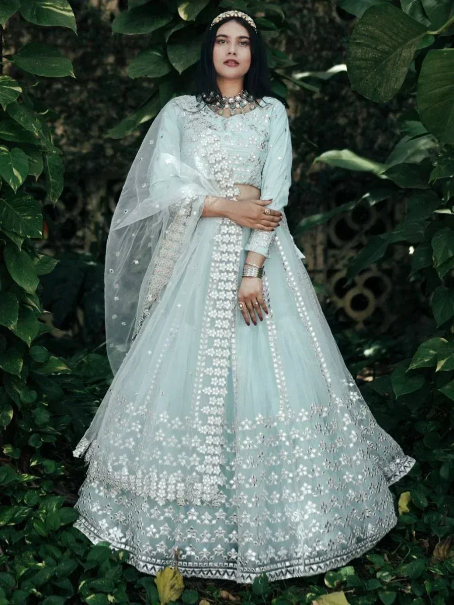 Mint green designer lehenga choli with floral embroidery, perfect for Indian weddings and festive occasions.