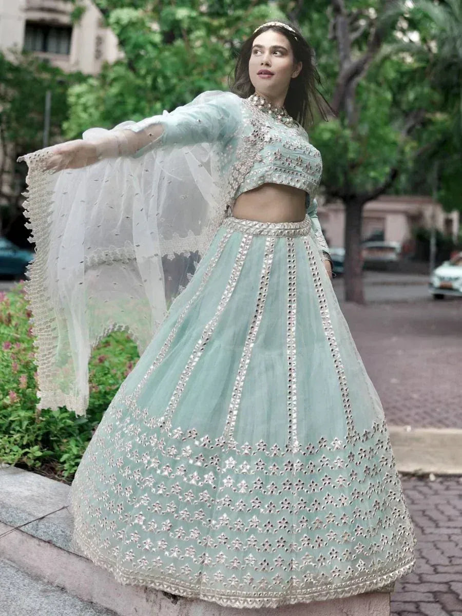 Mint green designer lehenga choli with silver embroidery and sheer dupatta, perfect for Indian ethnic wear events