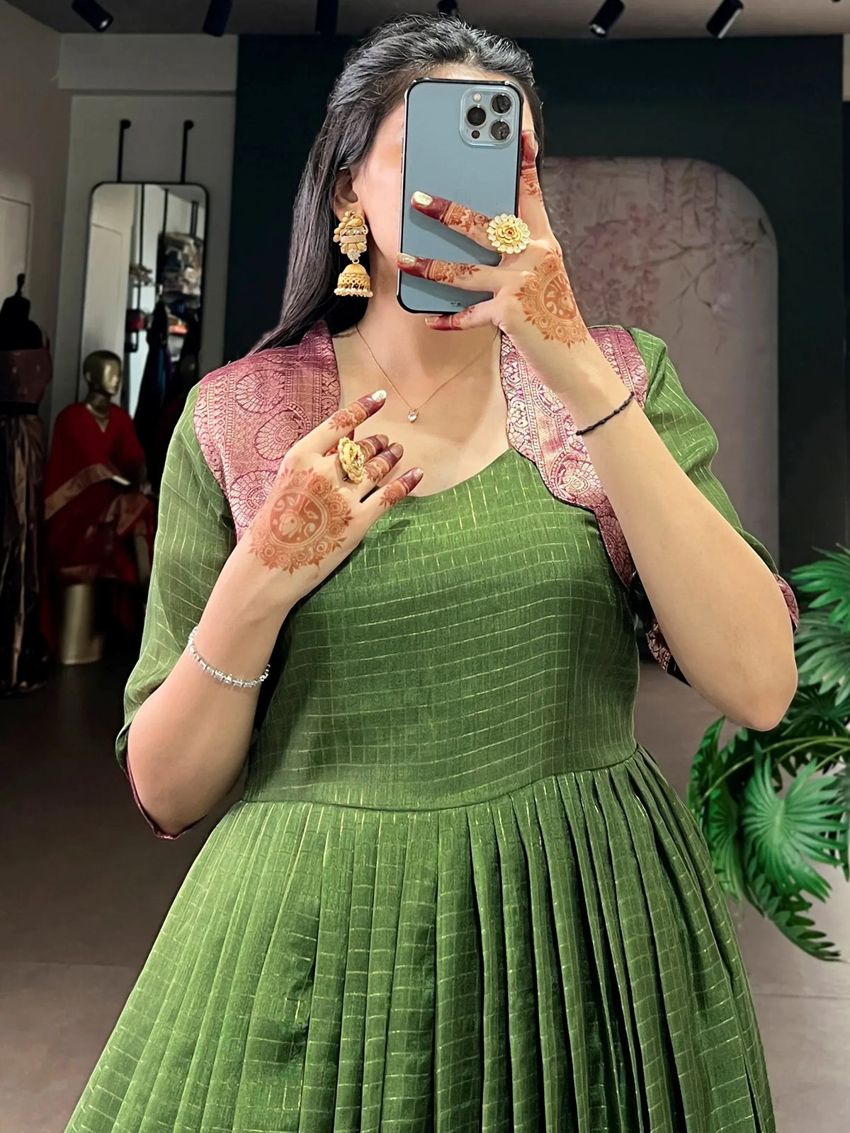 Green ethnic gown with pink embroidered yoke, perfect for Indian occasions and weddings.
