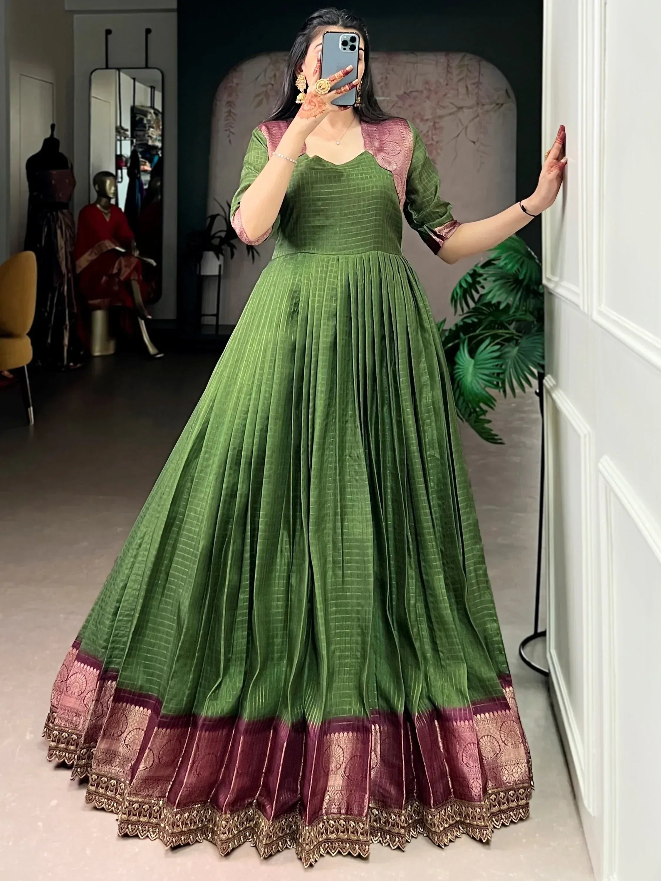 Green pleated ethnic gown with maroon border, perfect for Indian weddings and festive occasions.