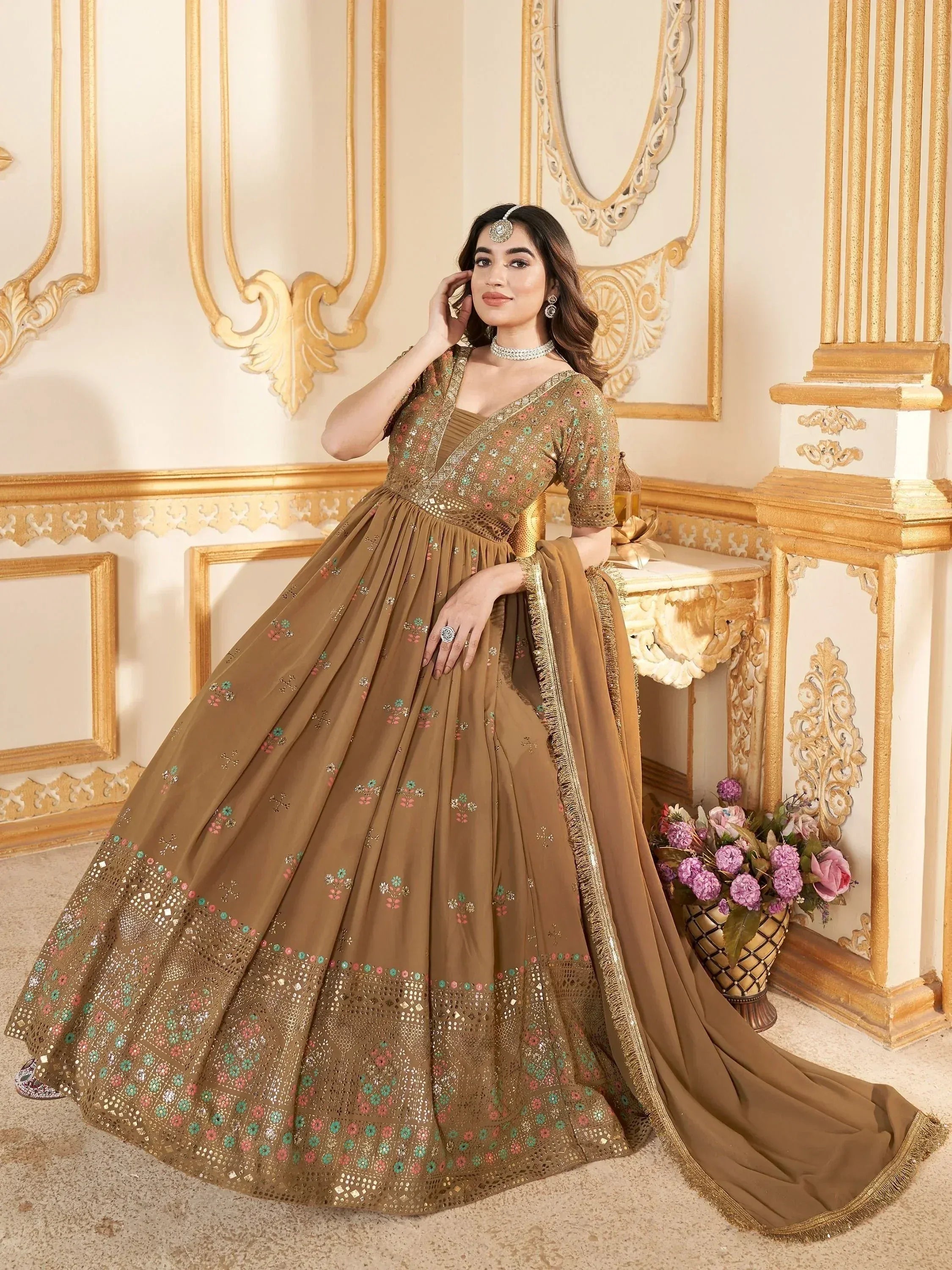 Elegant brown designer lehenga choli with floral embroidery and mirror work, perfect for Indian weddings and festive occasions.