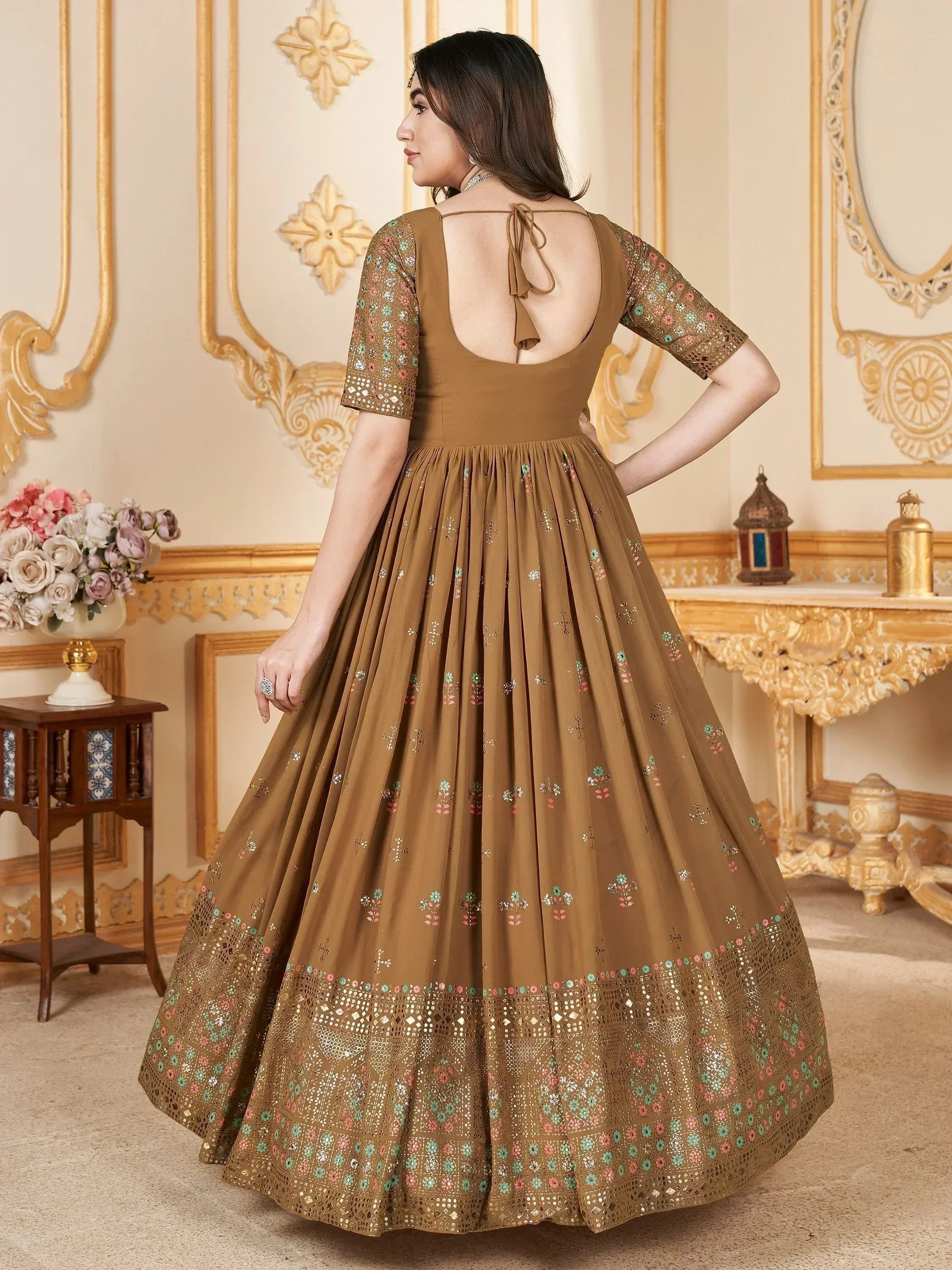 Brown embroidered lehenga choli with back tie, floral mirror work, and pleated skirt for Indian ethnic wear