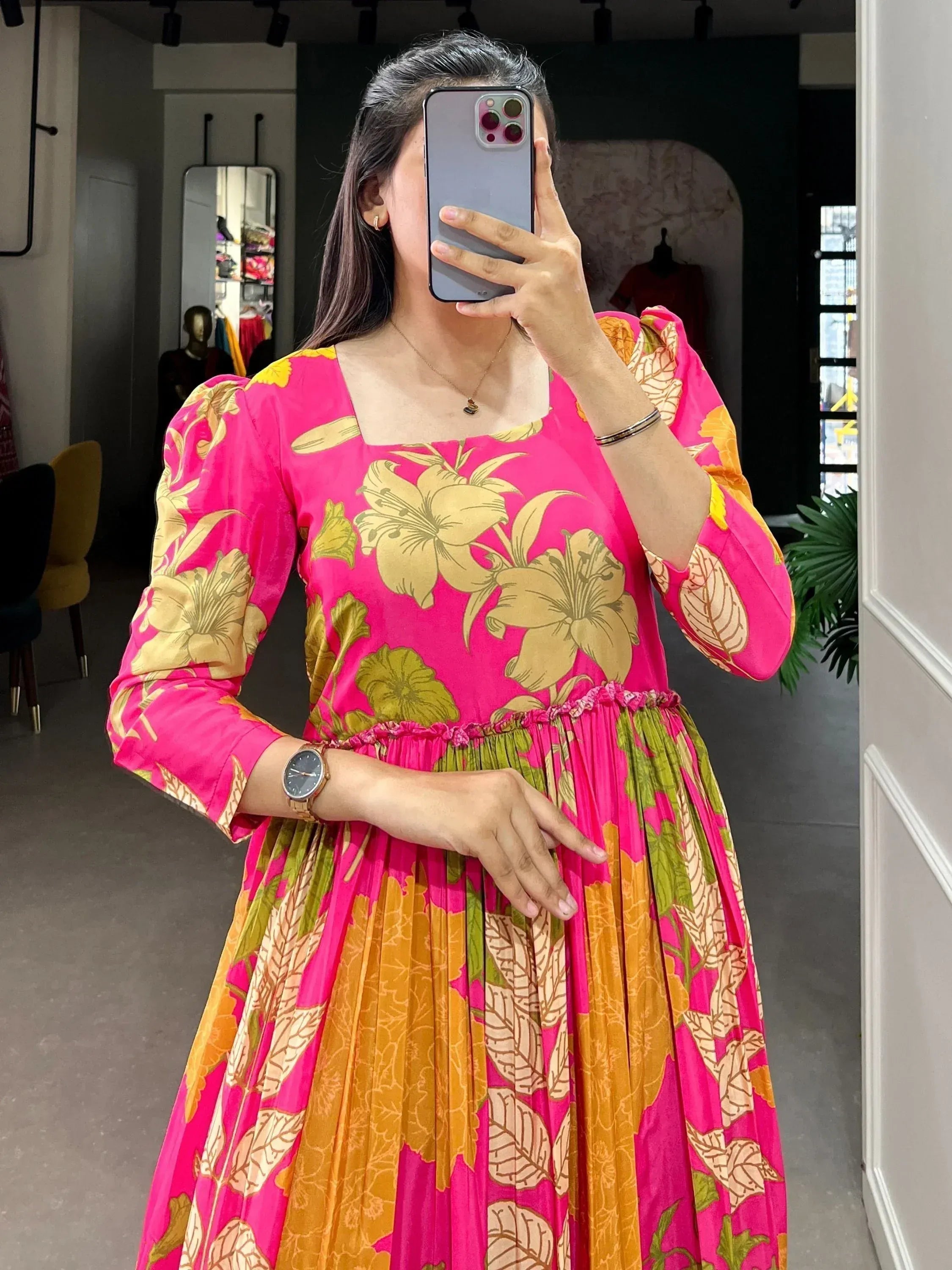 Vibrant pink floral ethnic gown with puff sleeves, perfect for Indian occasions and festive wear.