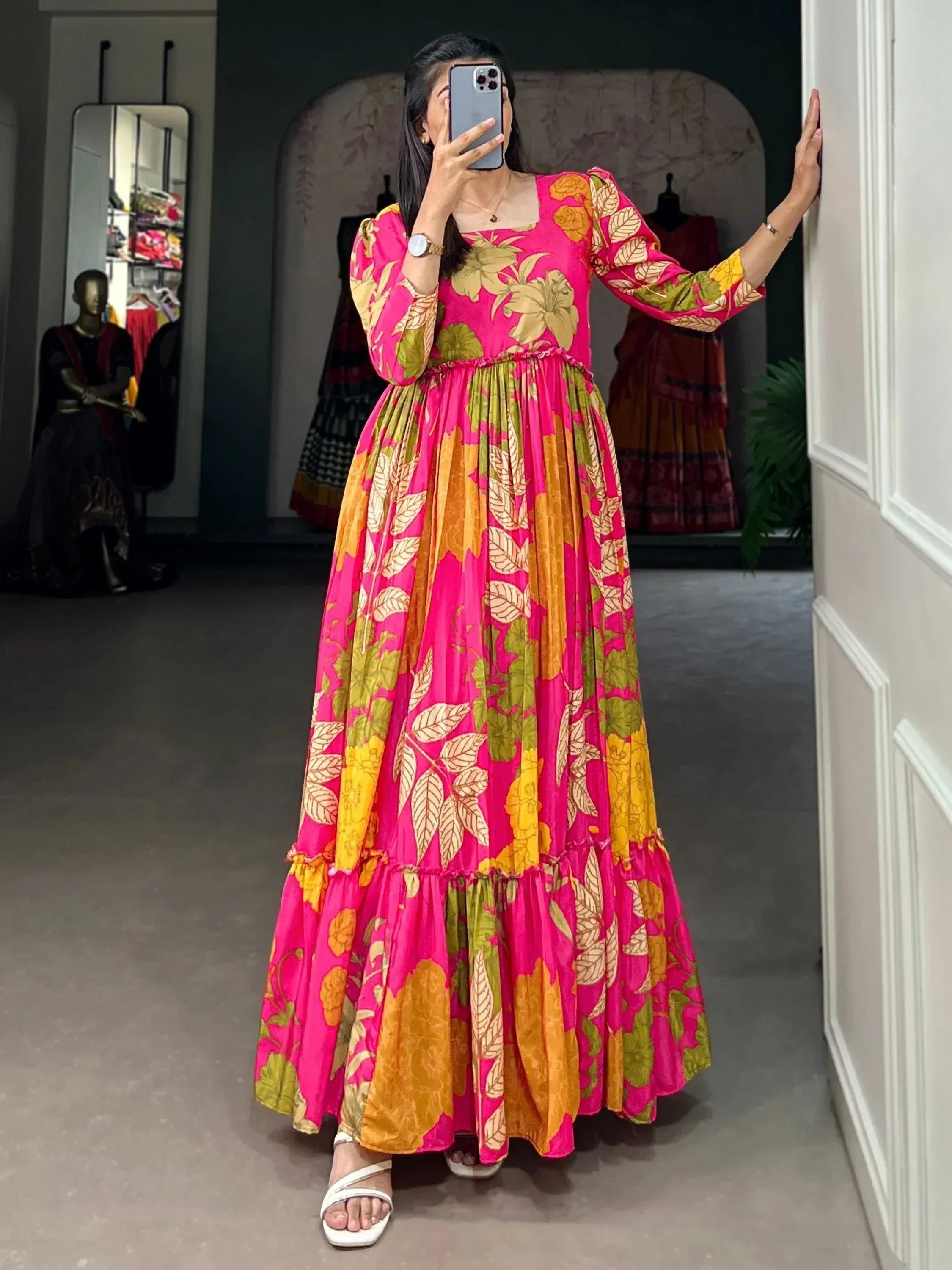 Vibrant pink floral ethnic gown with long sleeves and tiered skirt, perfect for festive occasions