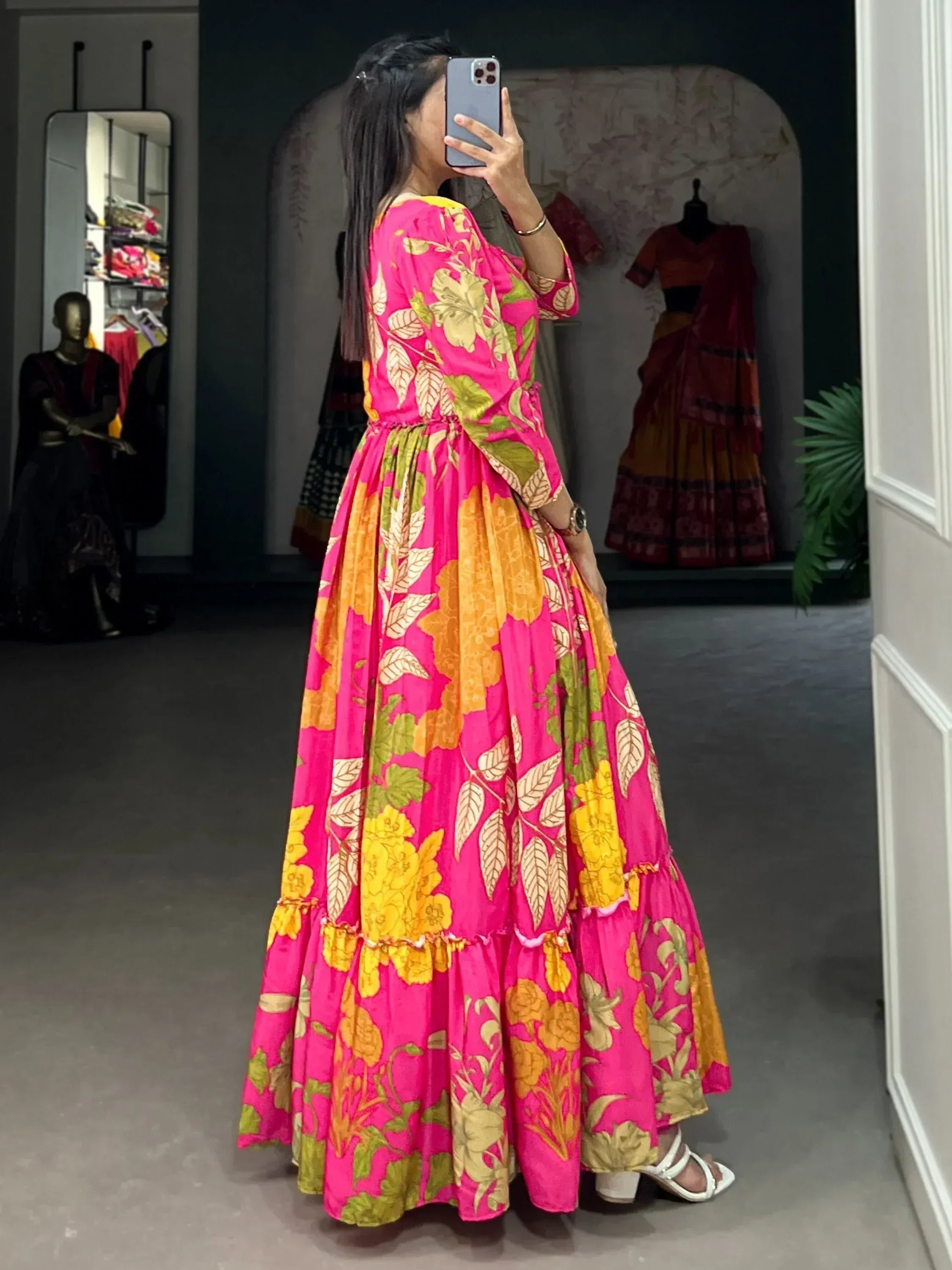 Vibrant pink floral ethnic gown with ruffled layers, perfect for festive occasions and Indian wear.