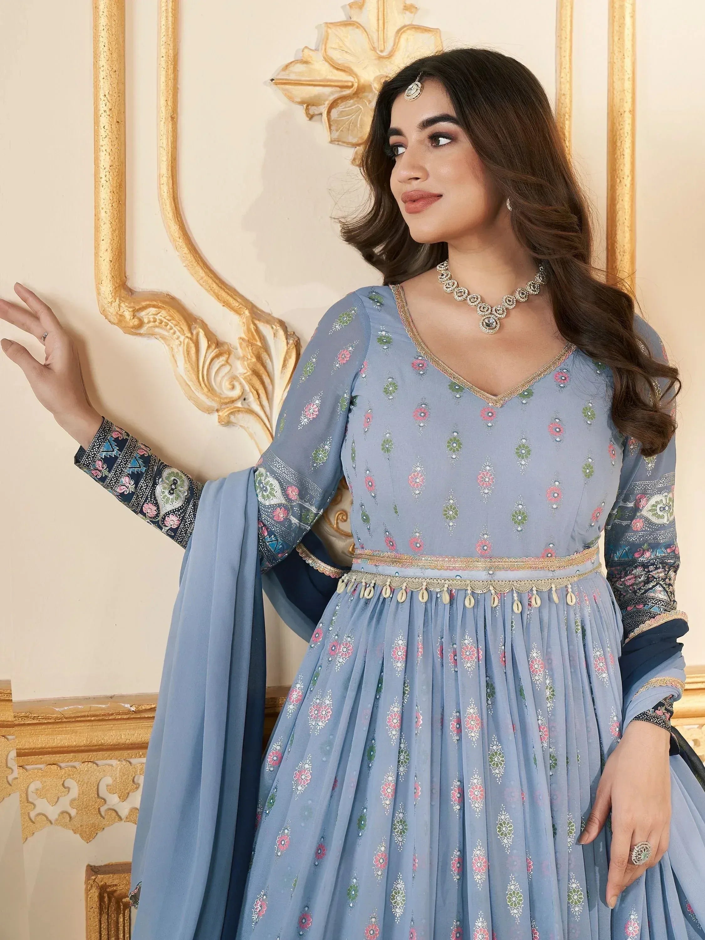 Blue floral printed ethnic gown with gold embroidery and dupatta, perfect for Indian occasions