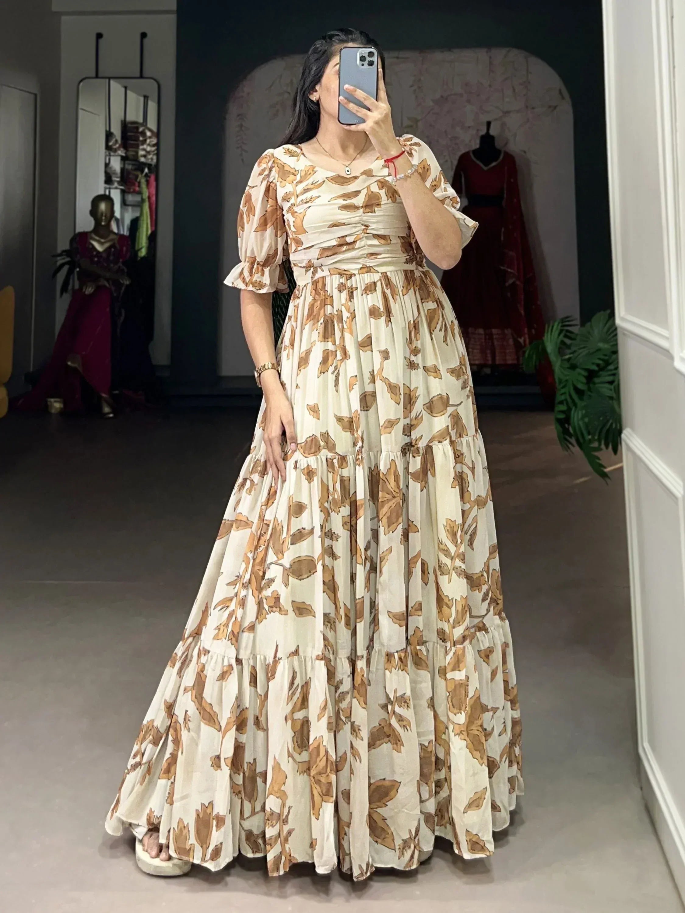 Woman wearing cream and brown floral floor-length ethnic gown with puff sleeves