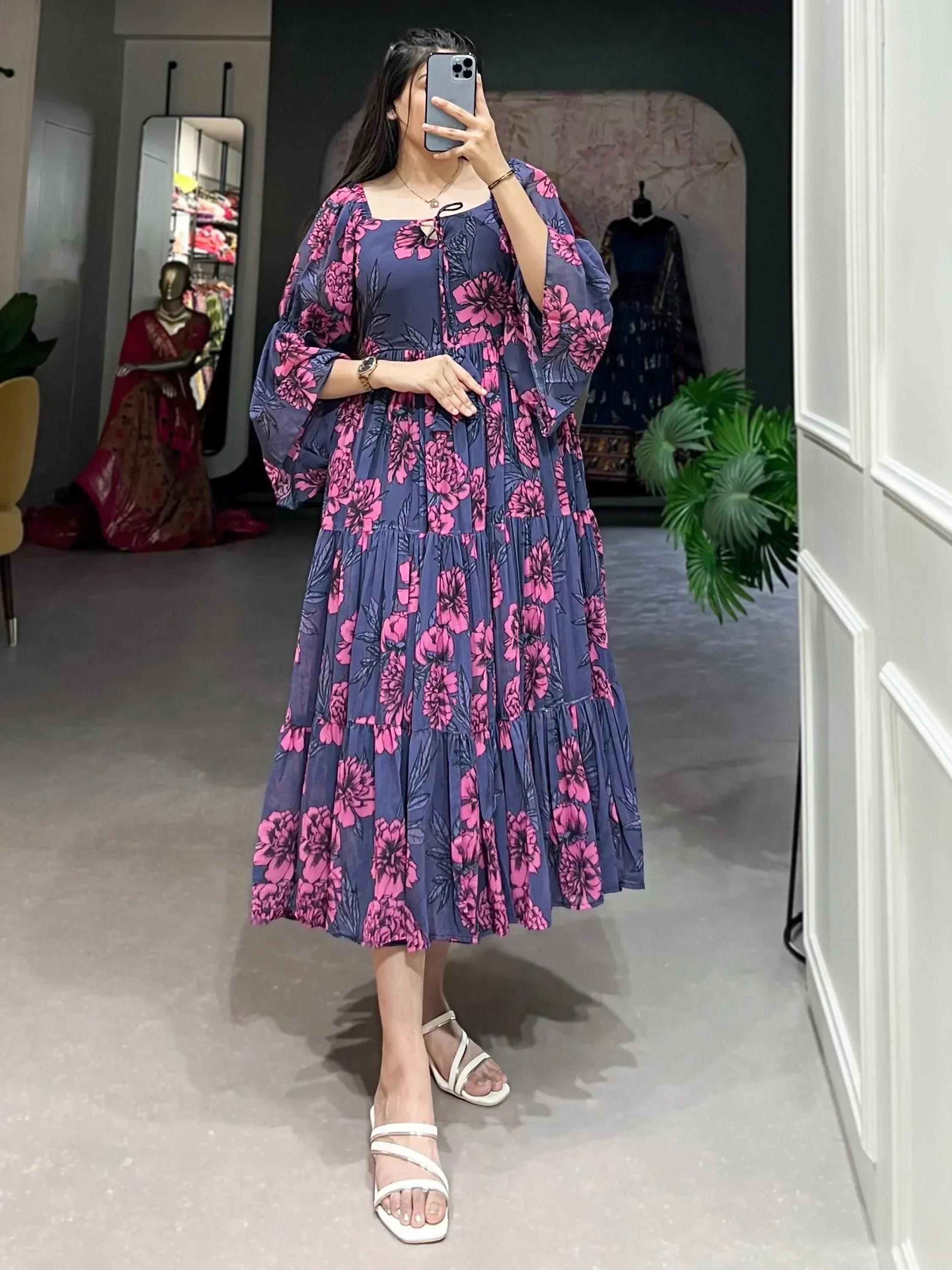 Navy blue floral ethnic gown with pink blooms, tiered skirt, and puff sleeves for women