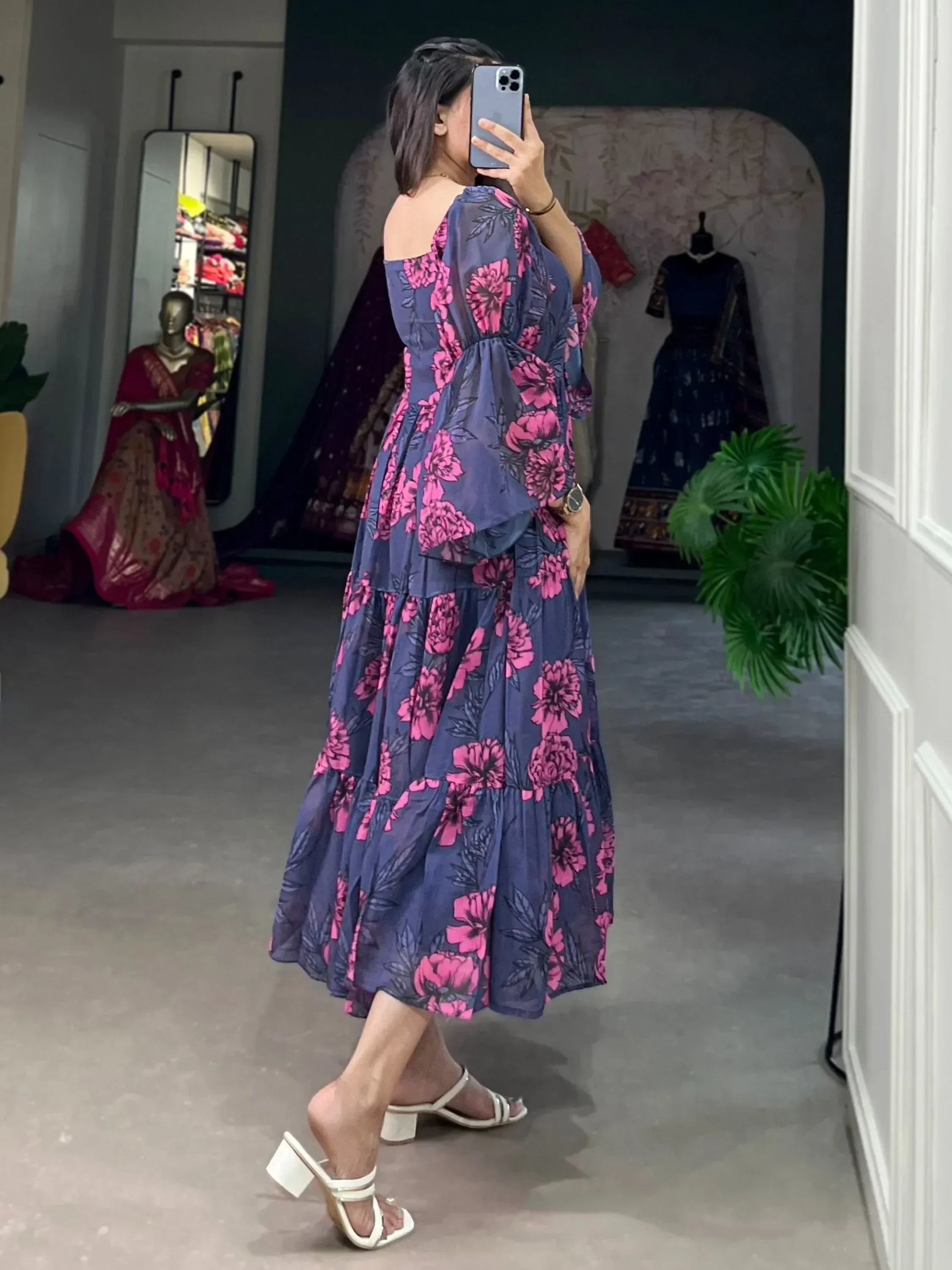 Woman in navy blue floral ethnic gown with off-shoulder sleeves, perfect for Indian occasions