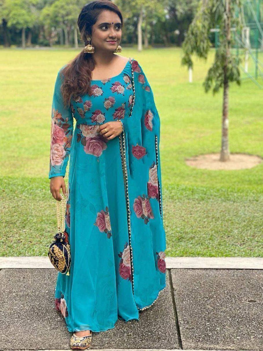 Turquoise floral ethnic gown with sheer sleeves, perfect for Indian occasions and festive wear