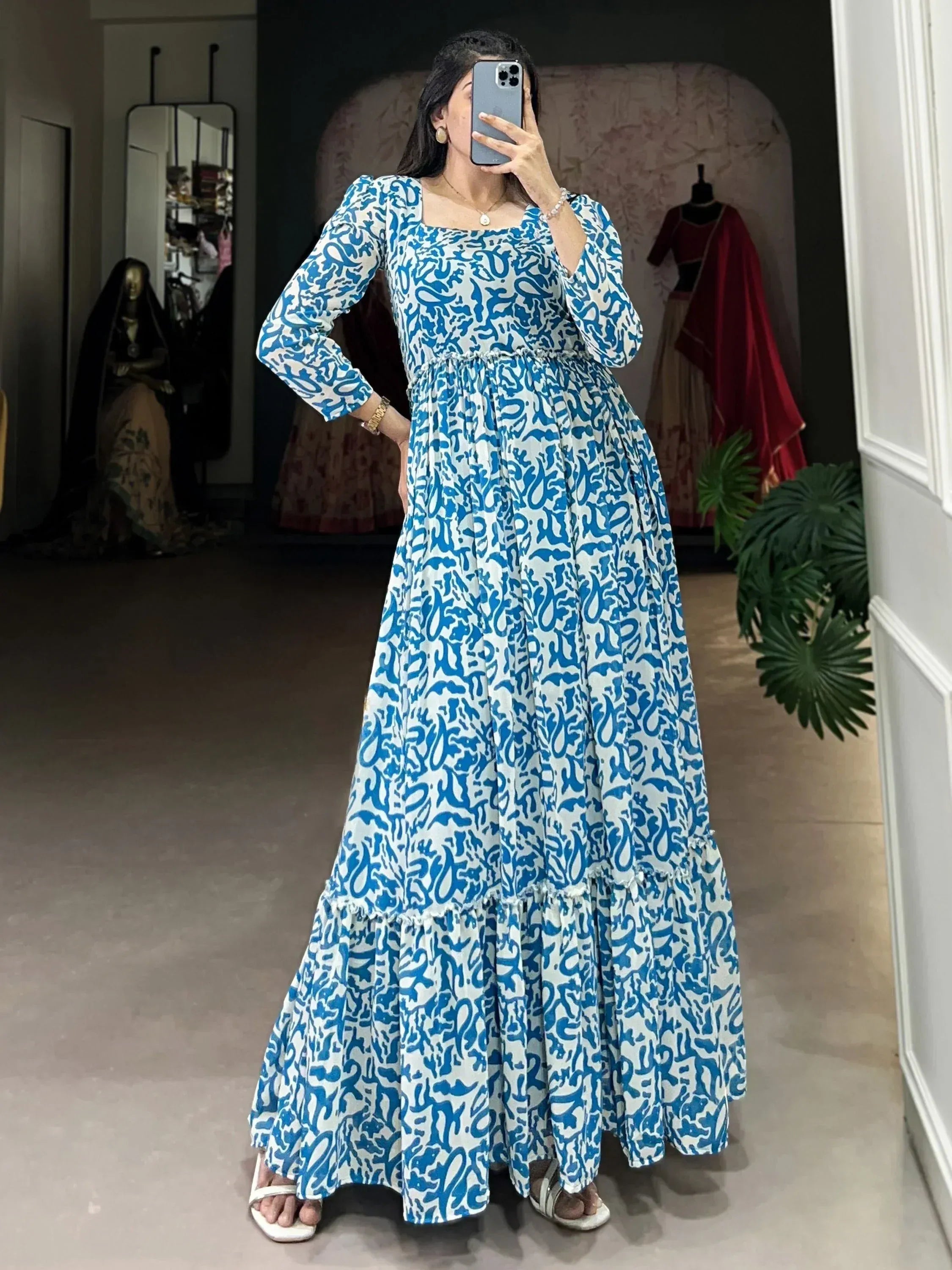 Blue and white printed ethnic maxi dress with puff sleeves and tiered skirt, perfect for festive occasions.