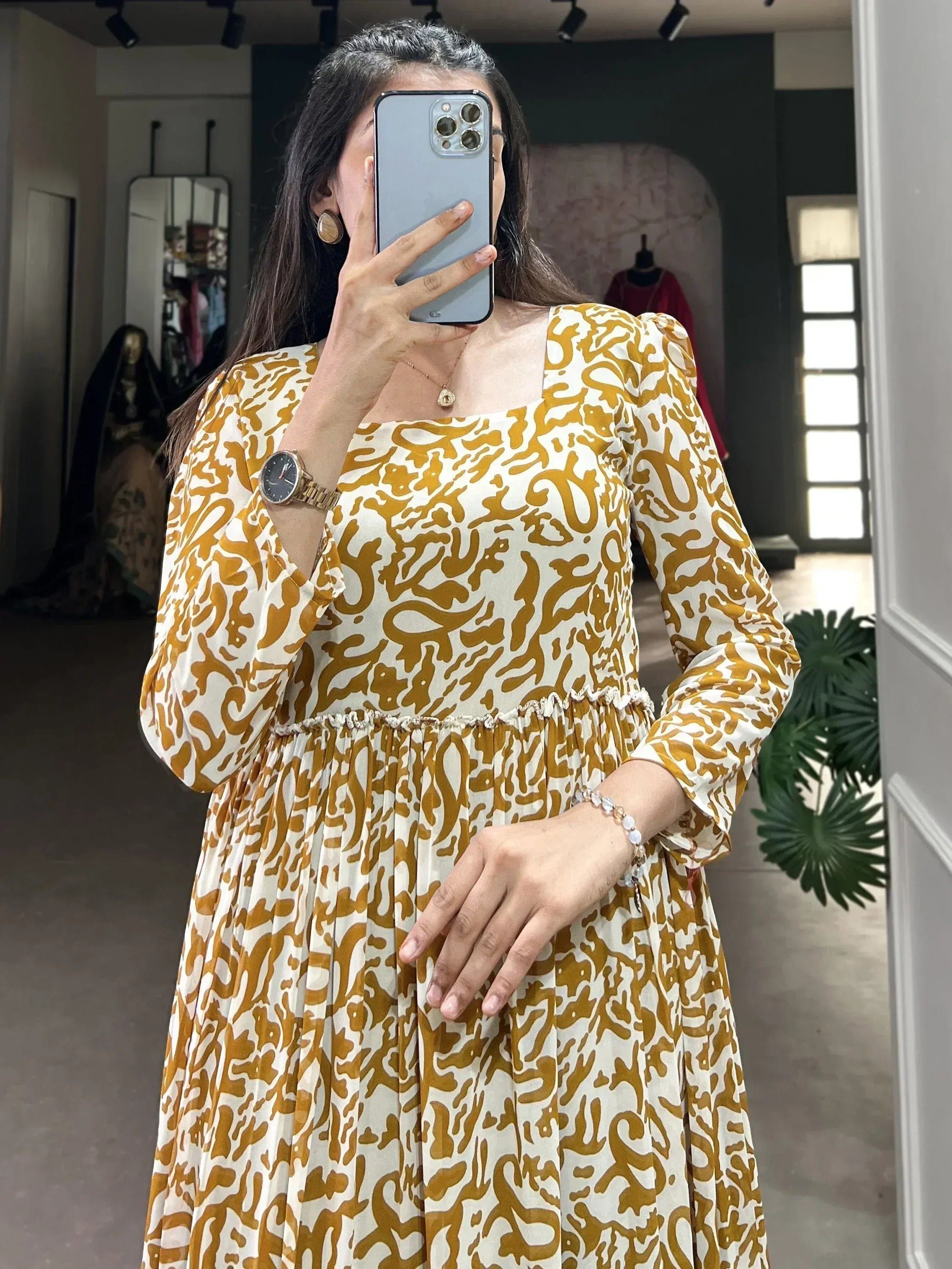 Elegant mustard and white printed ethnic gown with puff sleeves and pleated skirt