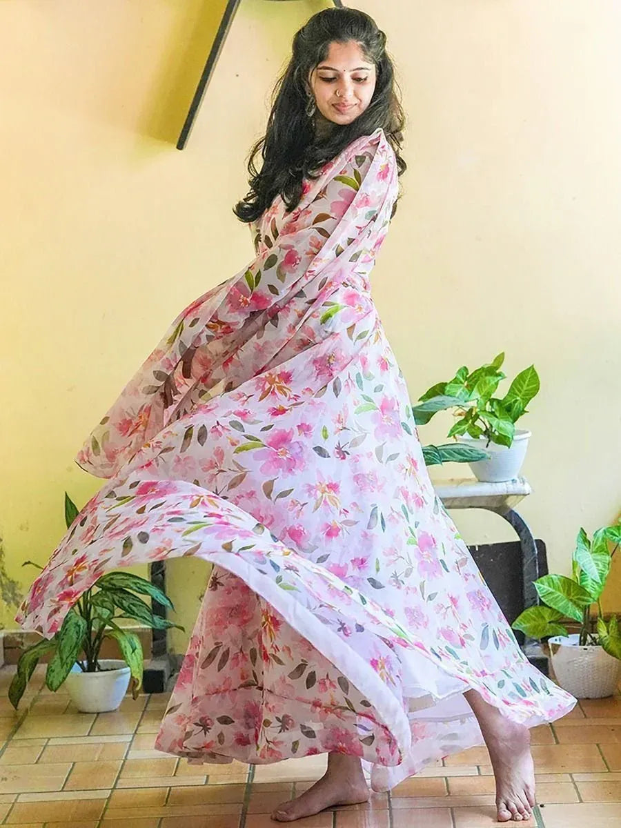 Woman twirling in floral print ethnic gown, perfect for Indian occasions and festive wear