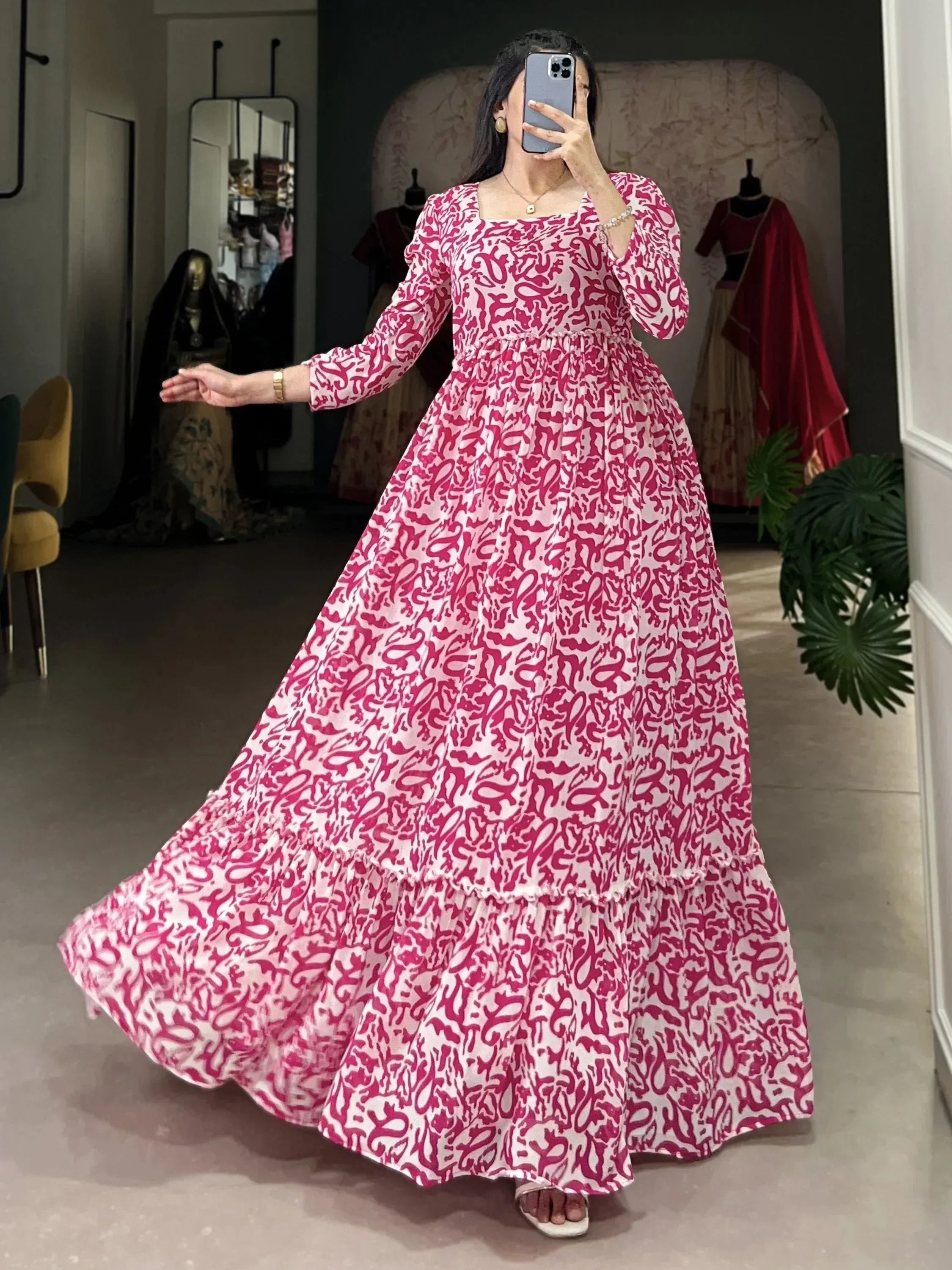 Pink and white printed ethnic gown with flared tiered skirt, perfect for festive occasions.