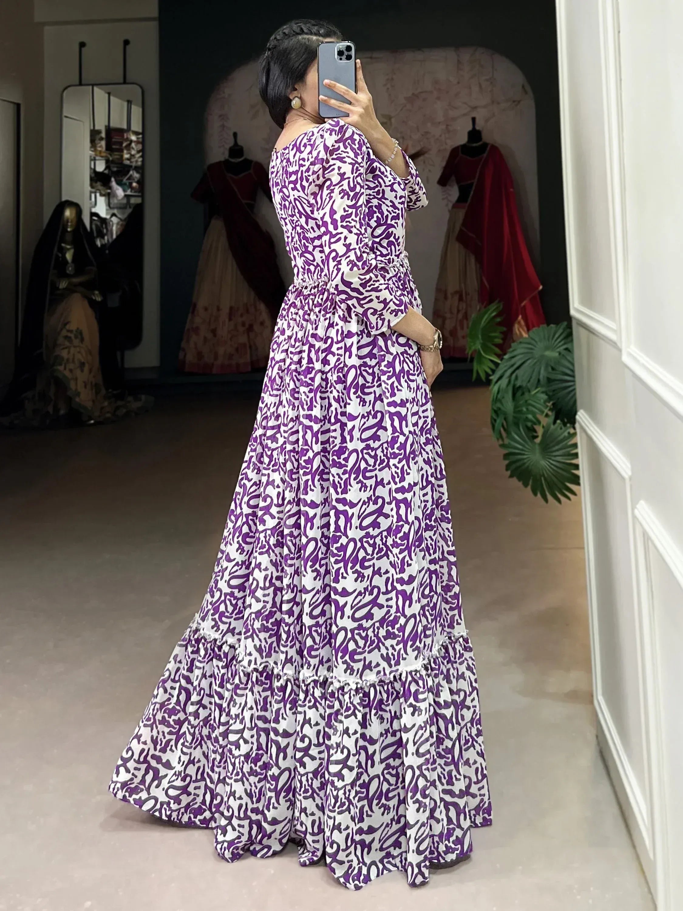 Purple and white printed ethnic gown with flared skirt, perfect for Indian occasions and festive wear.