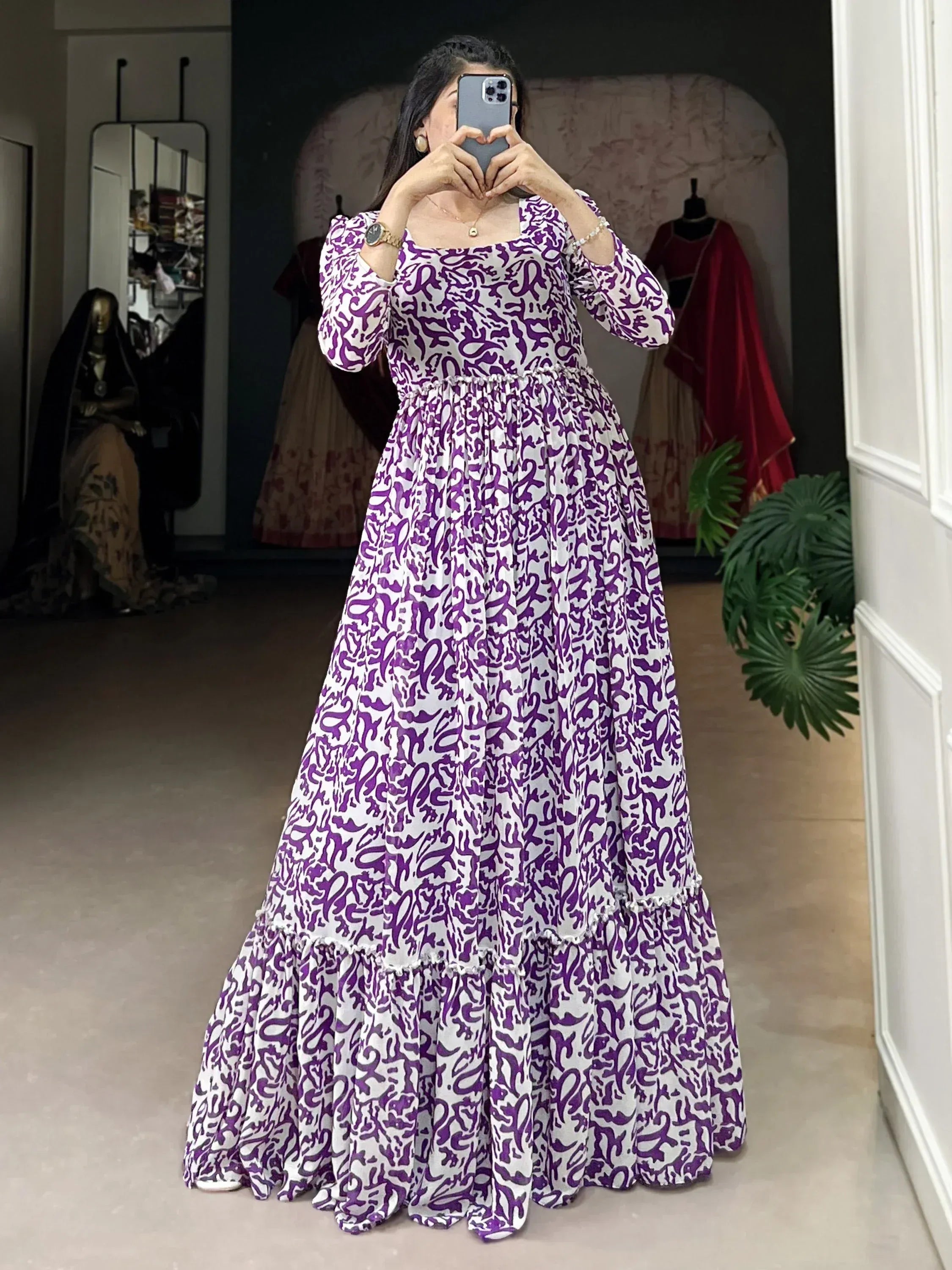 Purple and white printed ethnic gown with flared layers, perfect for festive occasions.