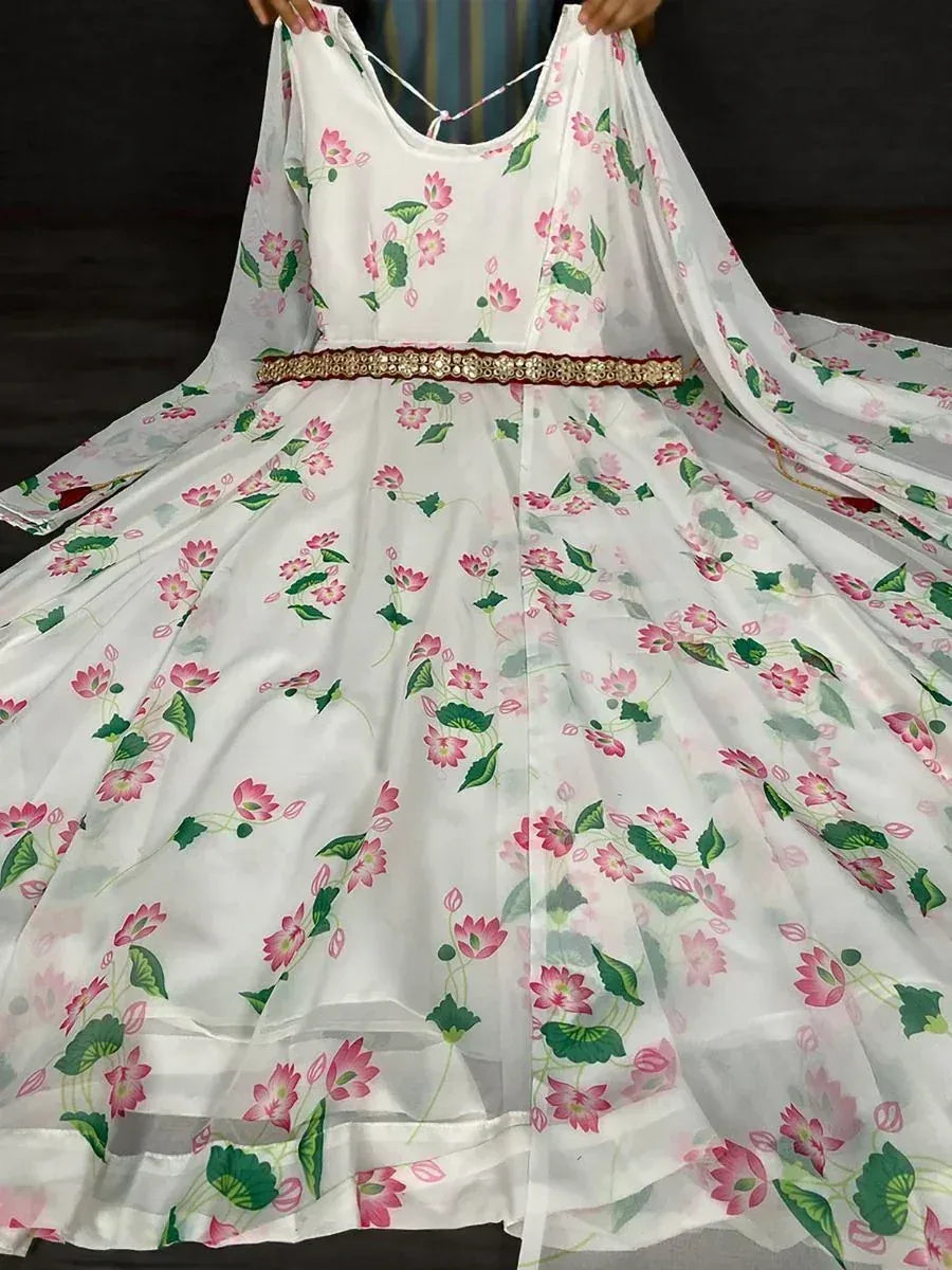 White floral ethnic gown with pink lotus print and sheer dupatta, featuring a decorative waistband.
