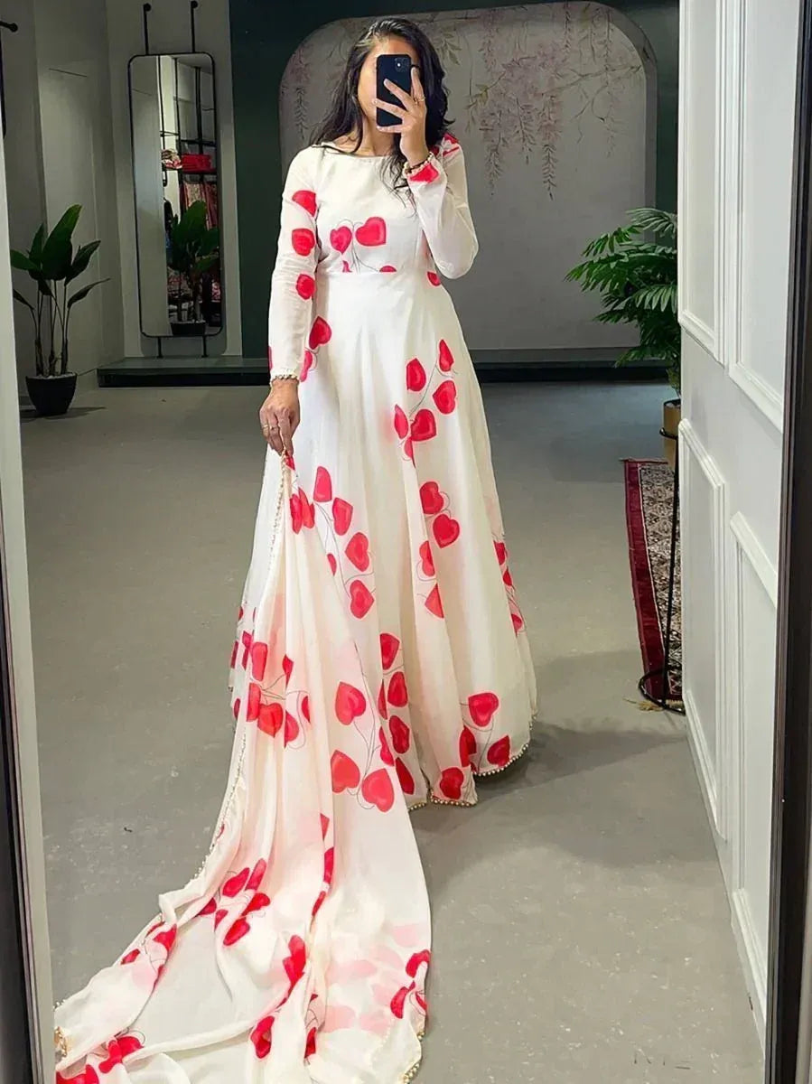 White ethnic gown with red heart print, long sleeves, and train, perfect for festive occasions