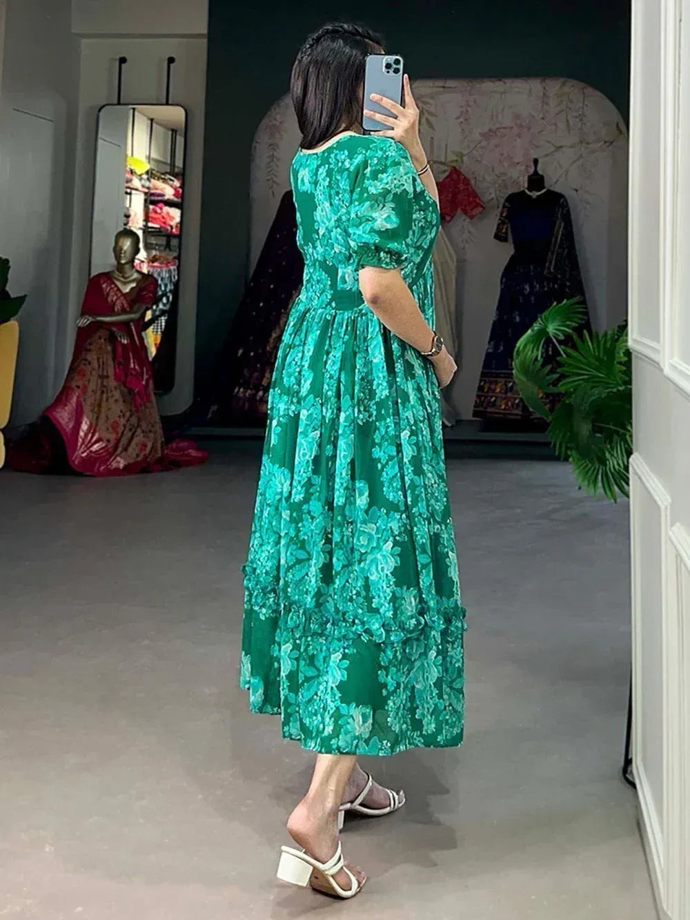 Woman in green floral ethnic gown taking mirror selfie, perfect for Indian occasions and parties
