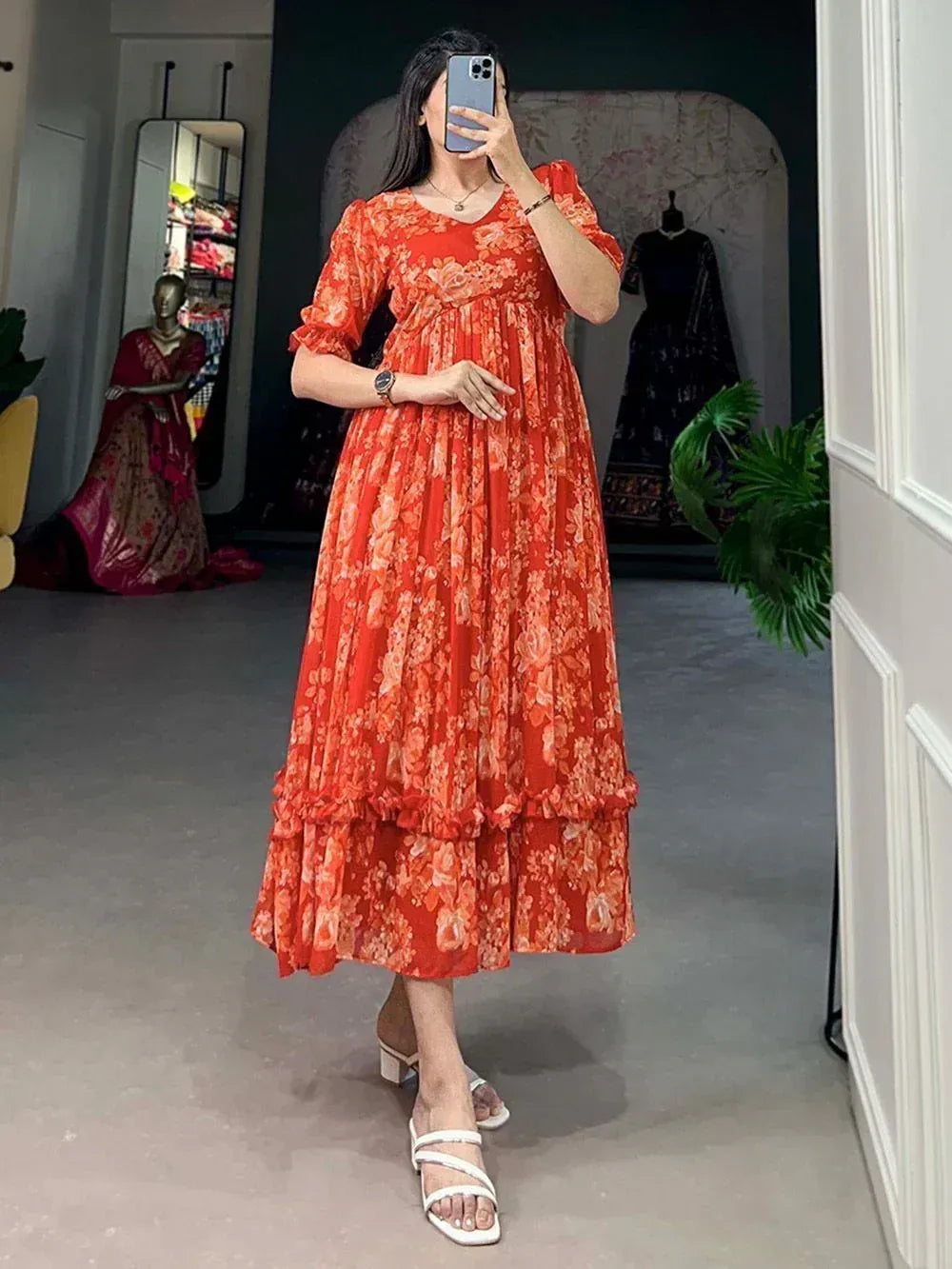 Orange floral ethnic gown with ruffled sleeves and tiered skirt, perfect for festive occasions