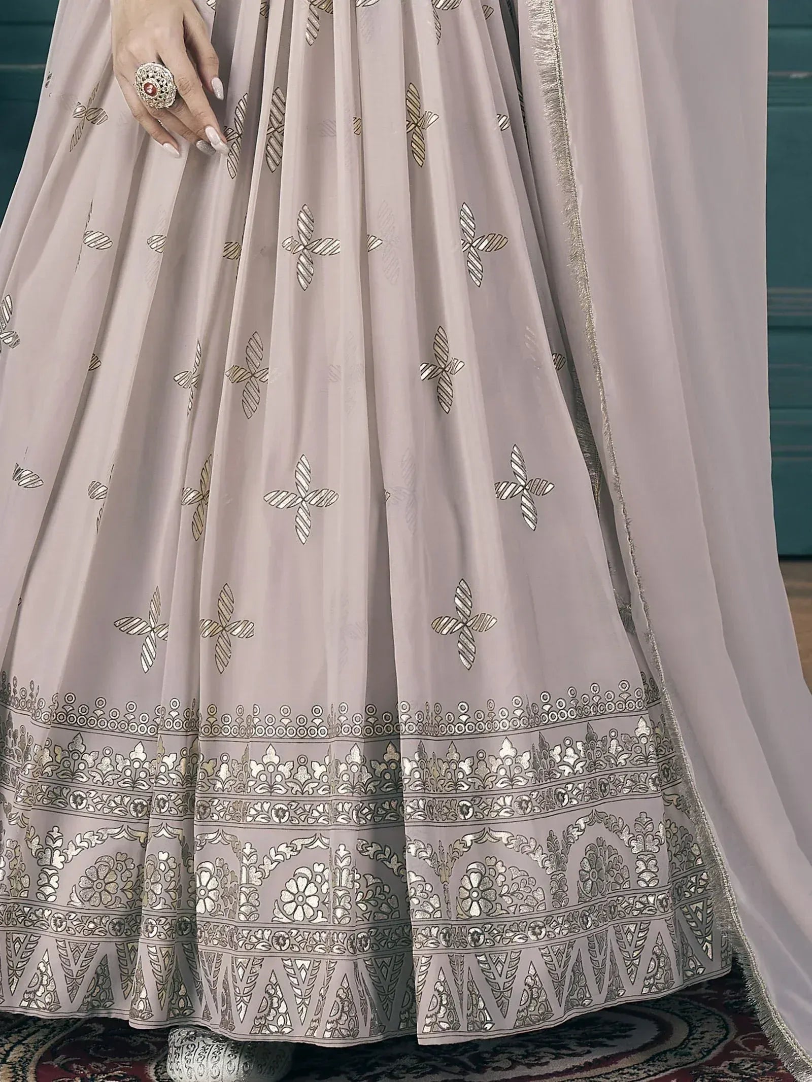 Elegant light pink lehenga with silver floral embroidery and detailed border, perfect for Indian ethnic wear.