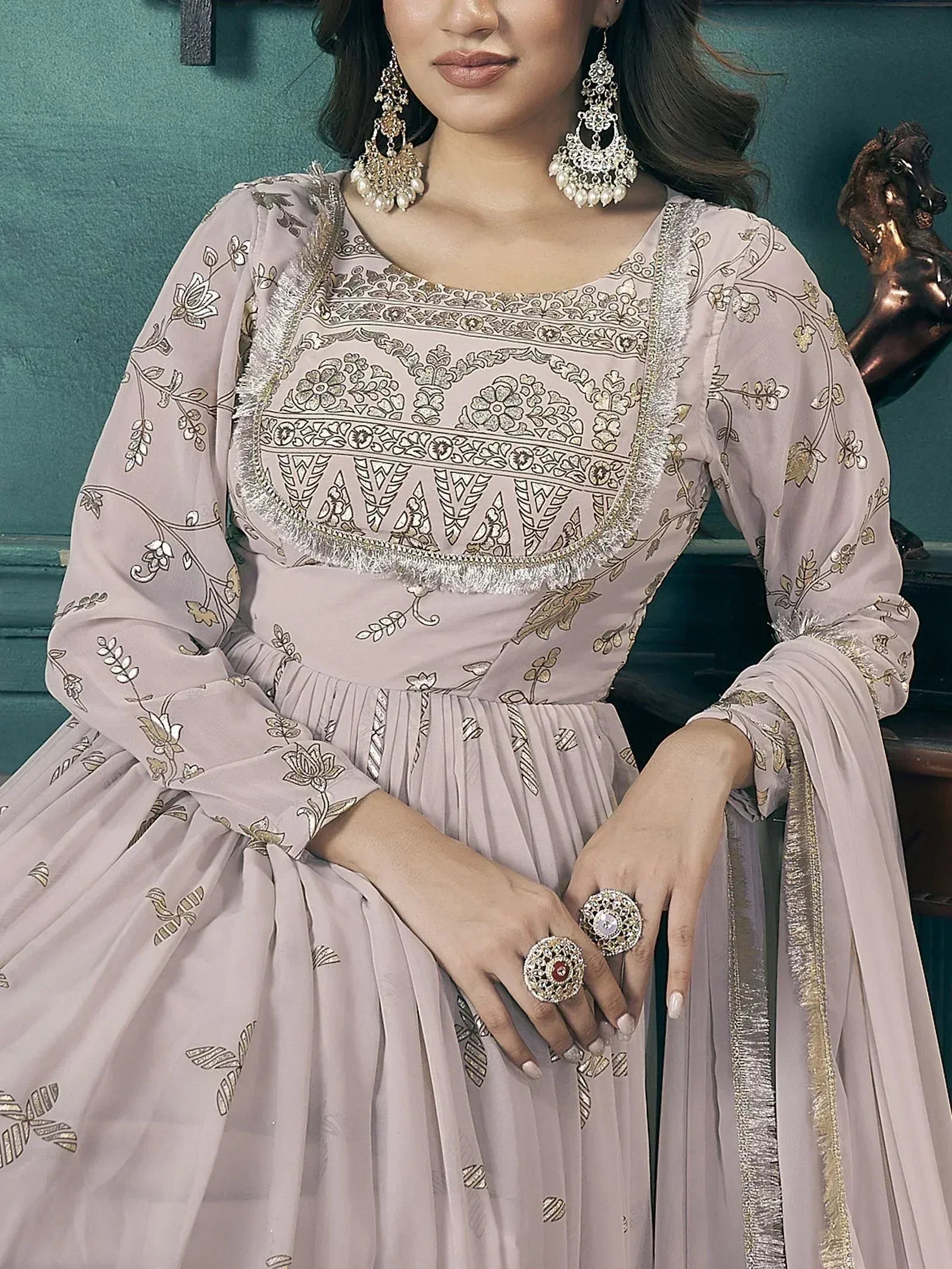 Elegant mauve ethnic gown with gold floral embroidery, perfect for Indian weddings or festive occasions.