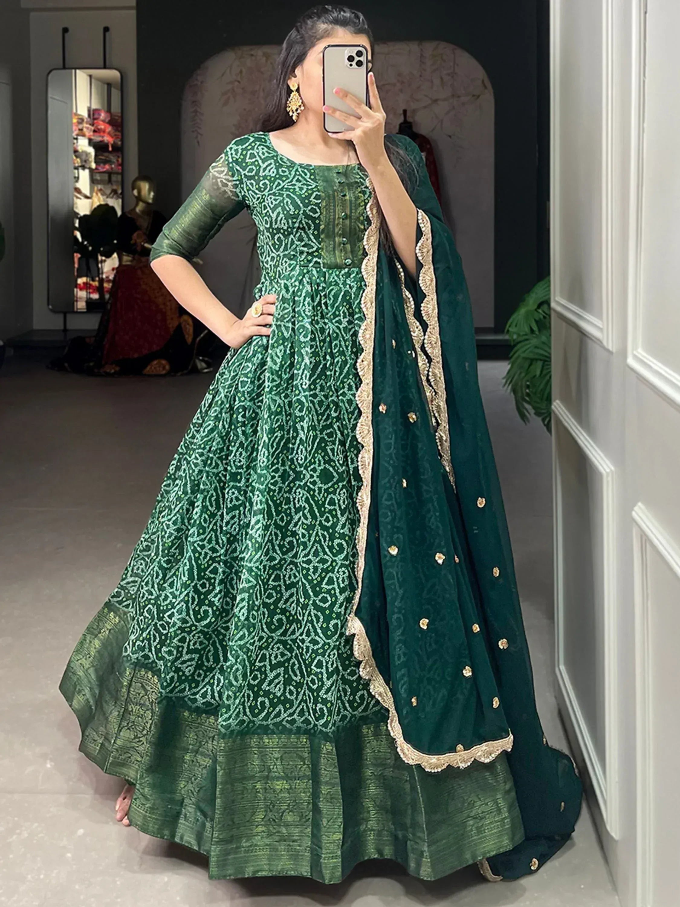 Emerald green designer anarkali with gold embroidery and matching dupatta, perfect for Indian ethnic occasions.