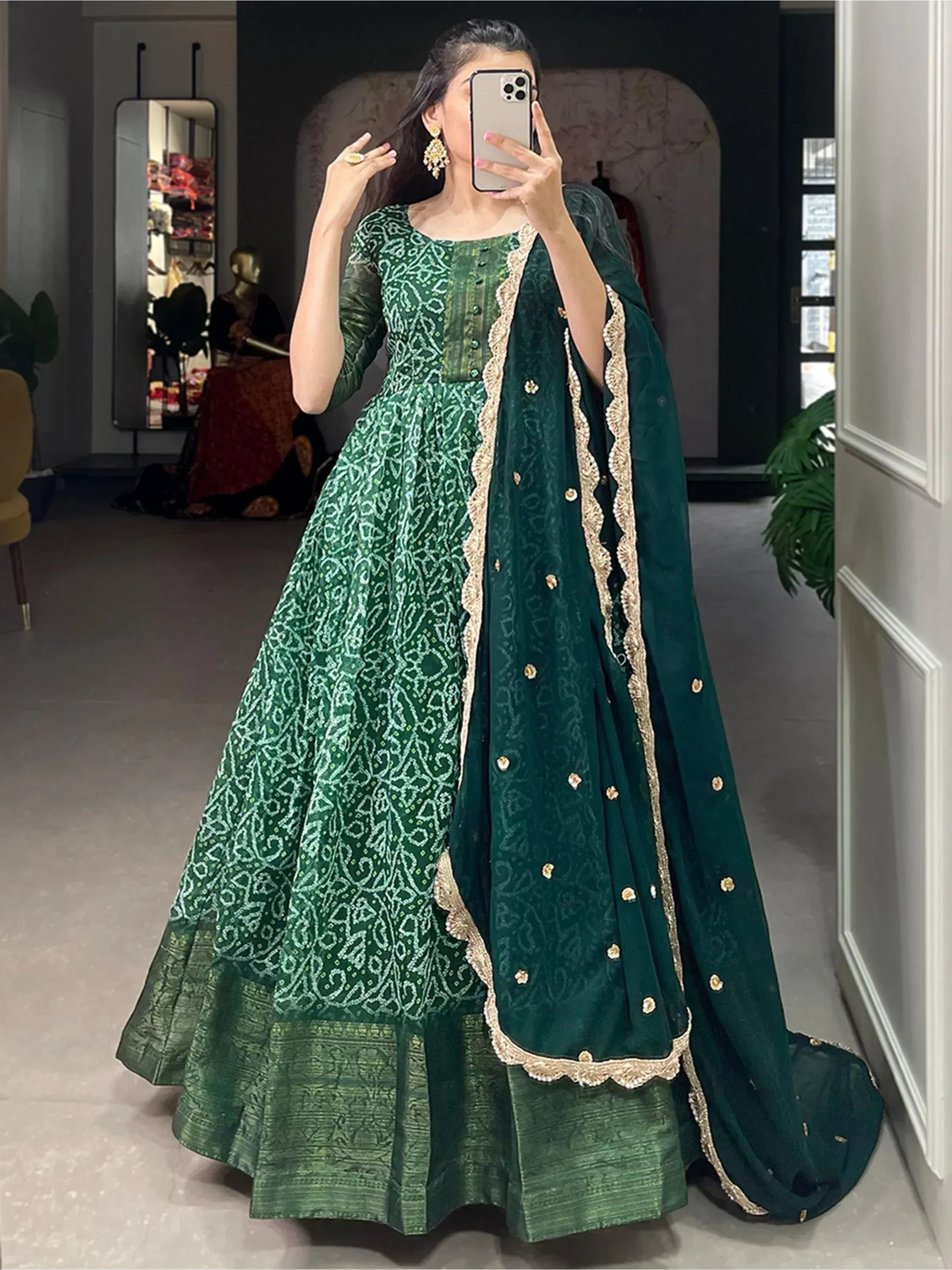 Emerald green ethnic anarkali gown with gold embroidery and matching dupatta, perfect for weddings and parties.