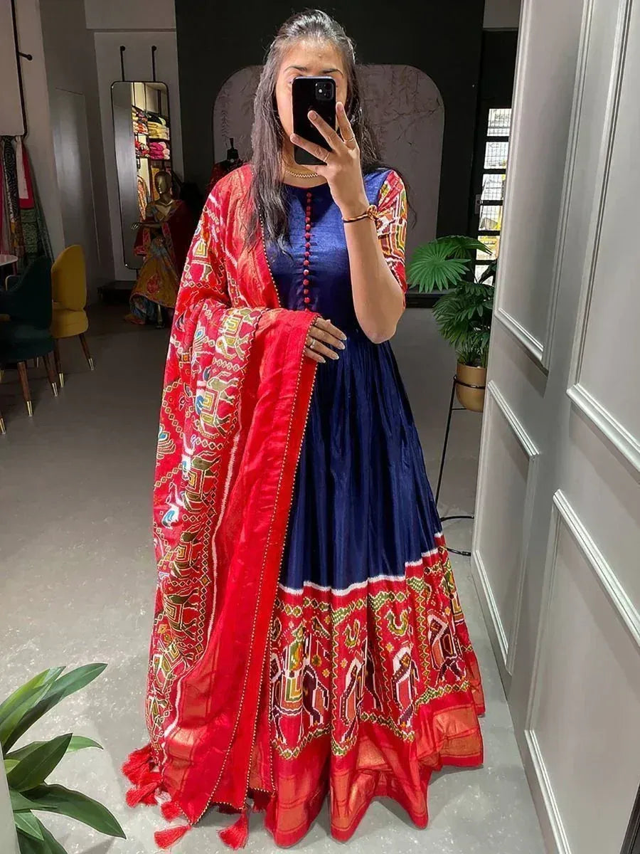 Woman in blue ethnic gown with red printed dupatta, mirror selfie in boutique