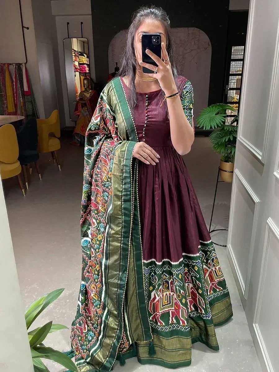 Woman in maroon ethnic gown with green printed dupatta, perfect for Indian occasions and festive wear.