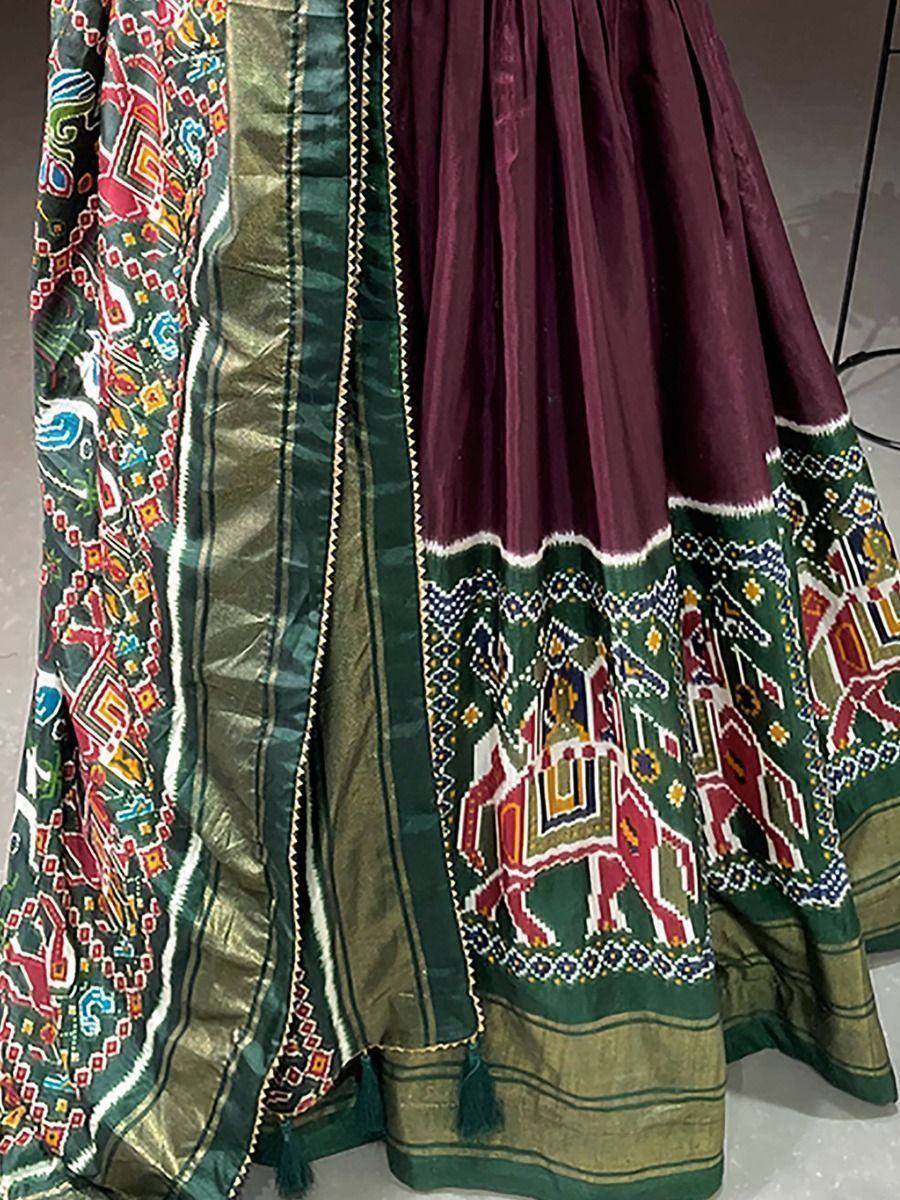 Maroon and green ethnic lehenga with elephant print and embroidered border, traditional Indian wear