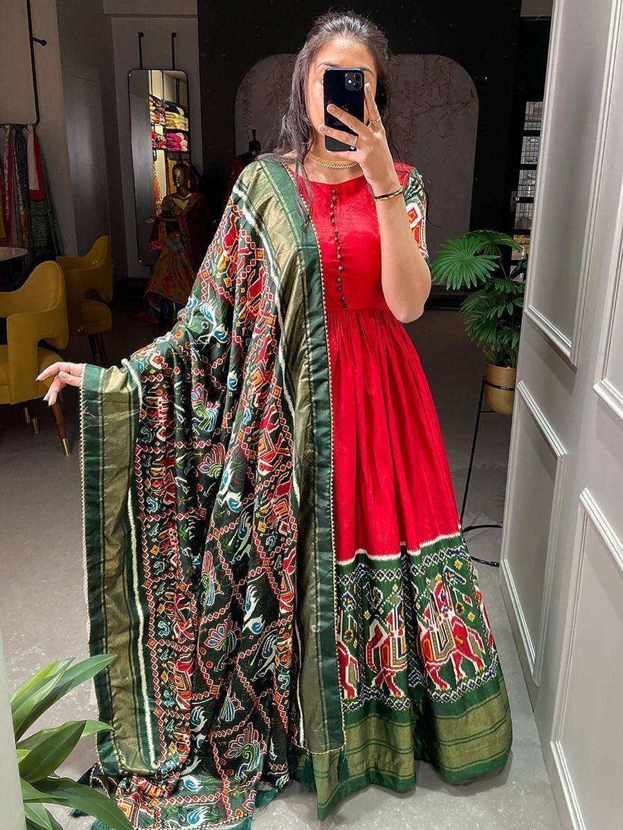 Red and green embroidered ethnic gown with matching dupatta, perfect for Indian celebrations and festive occasions.