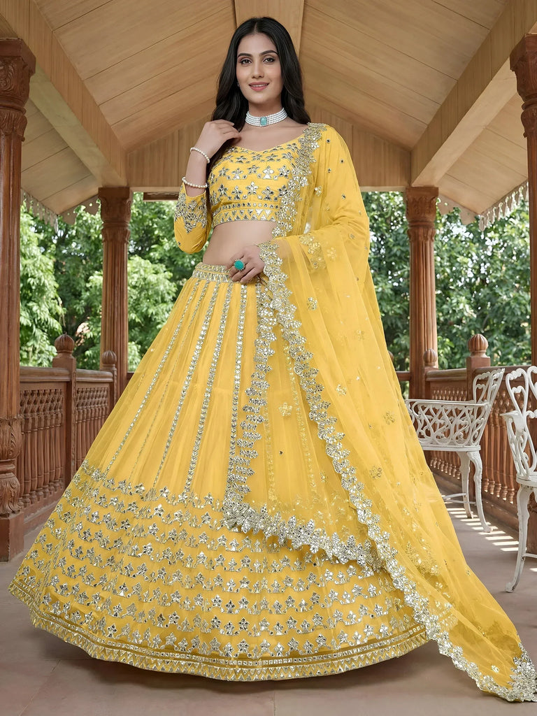Yellow designer lehenga choli with heavy silver mirror work, perfect for weddings and festivals