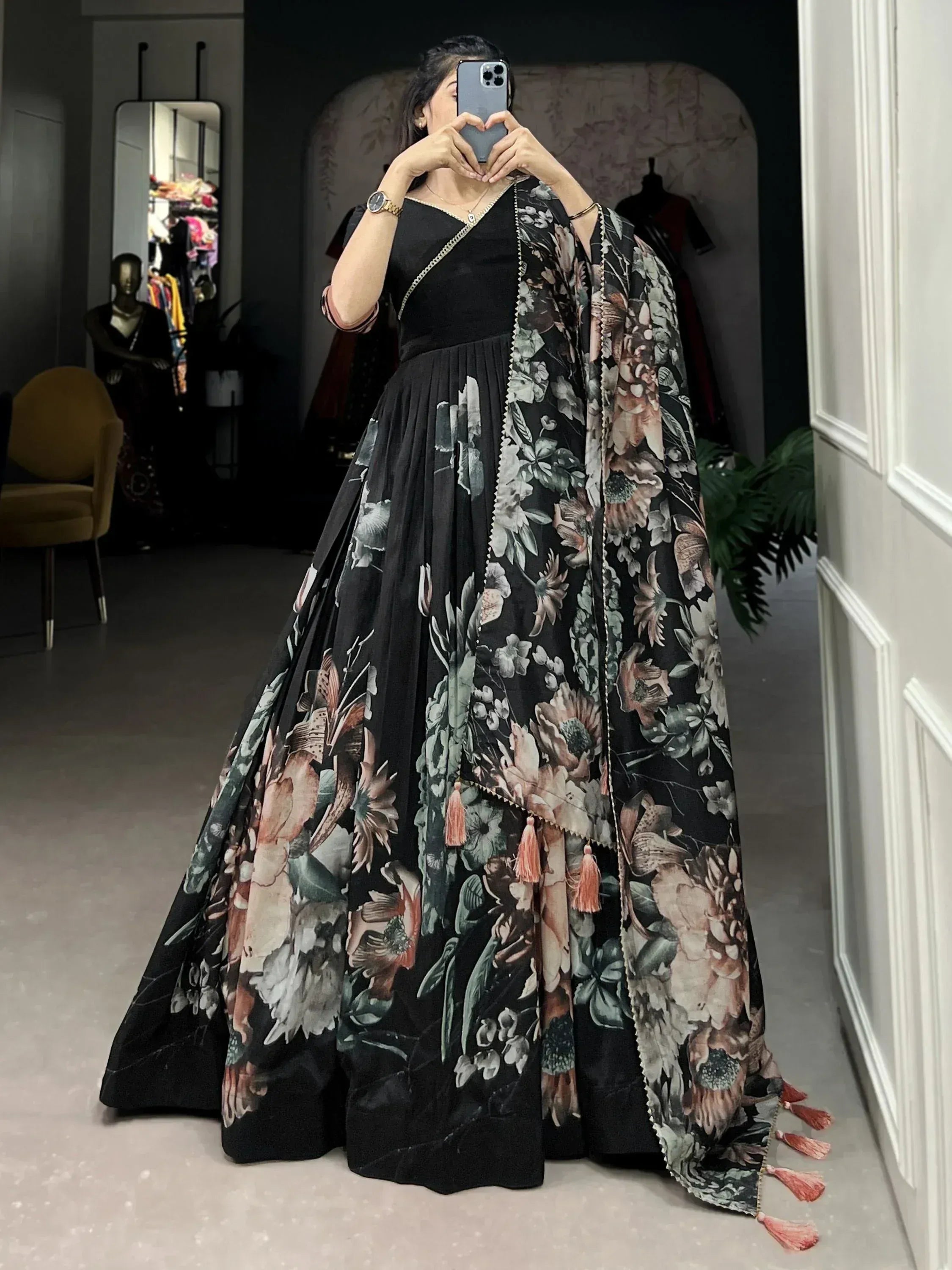 Black floral print ethnic gown with tassels, perfect for Indian occasions and events.