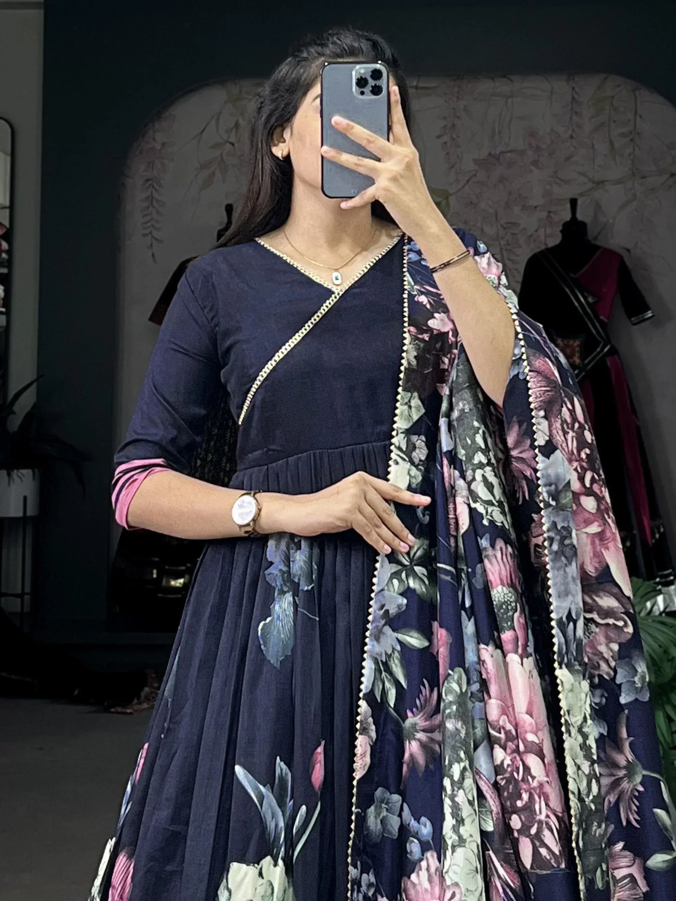 Navy blue floral print ethnic gown with gold trim, perfect for Indian occasions and festive wear.