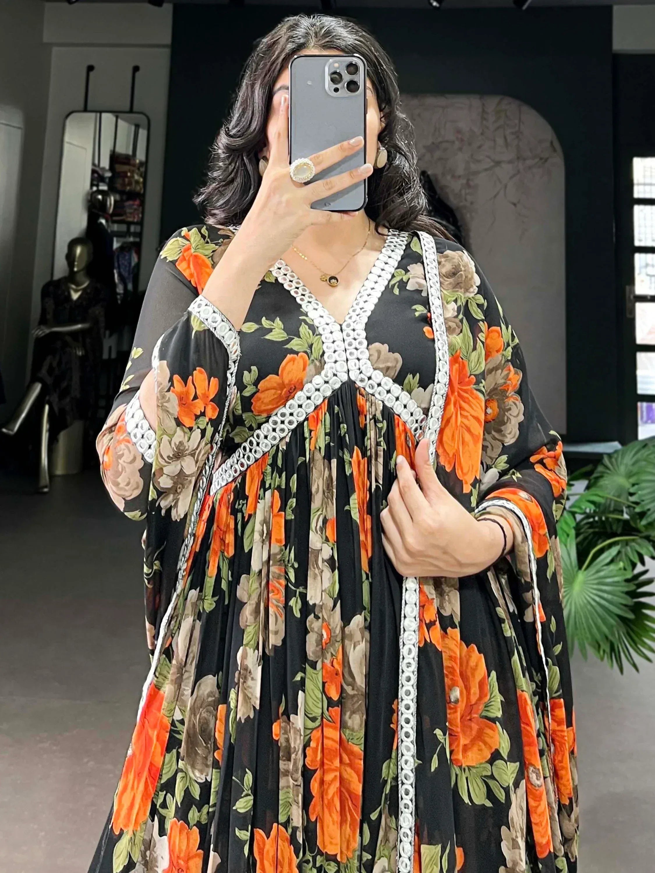 Black floral ethnic gown with orange blooms and white embroidery, perfect for Indian occasions.