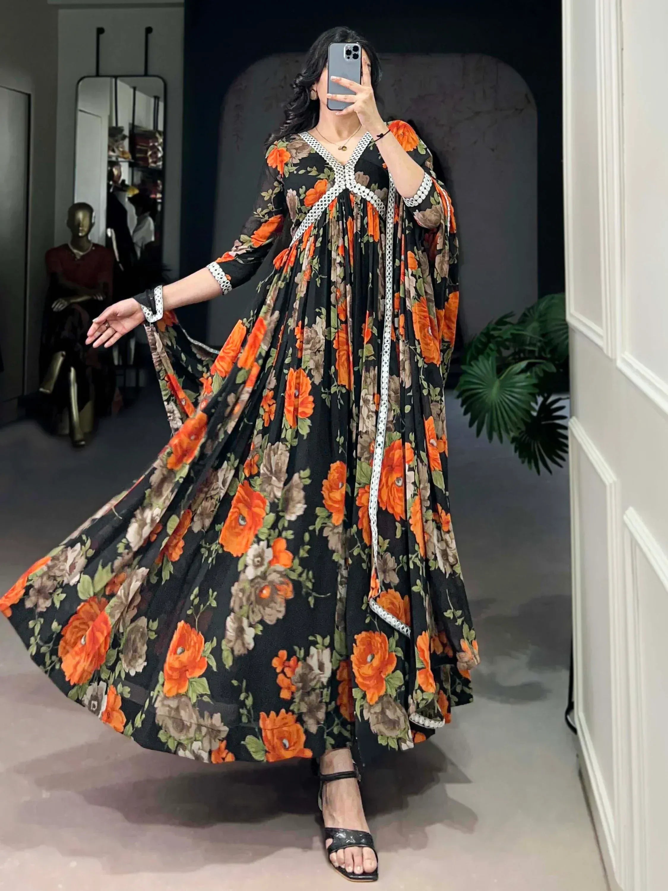 Black floral ethnic gown with orange roses and white lace trim, perfect for Indian occasions