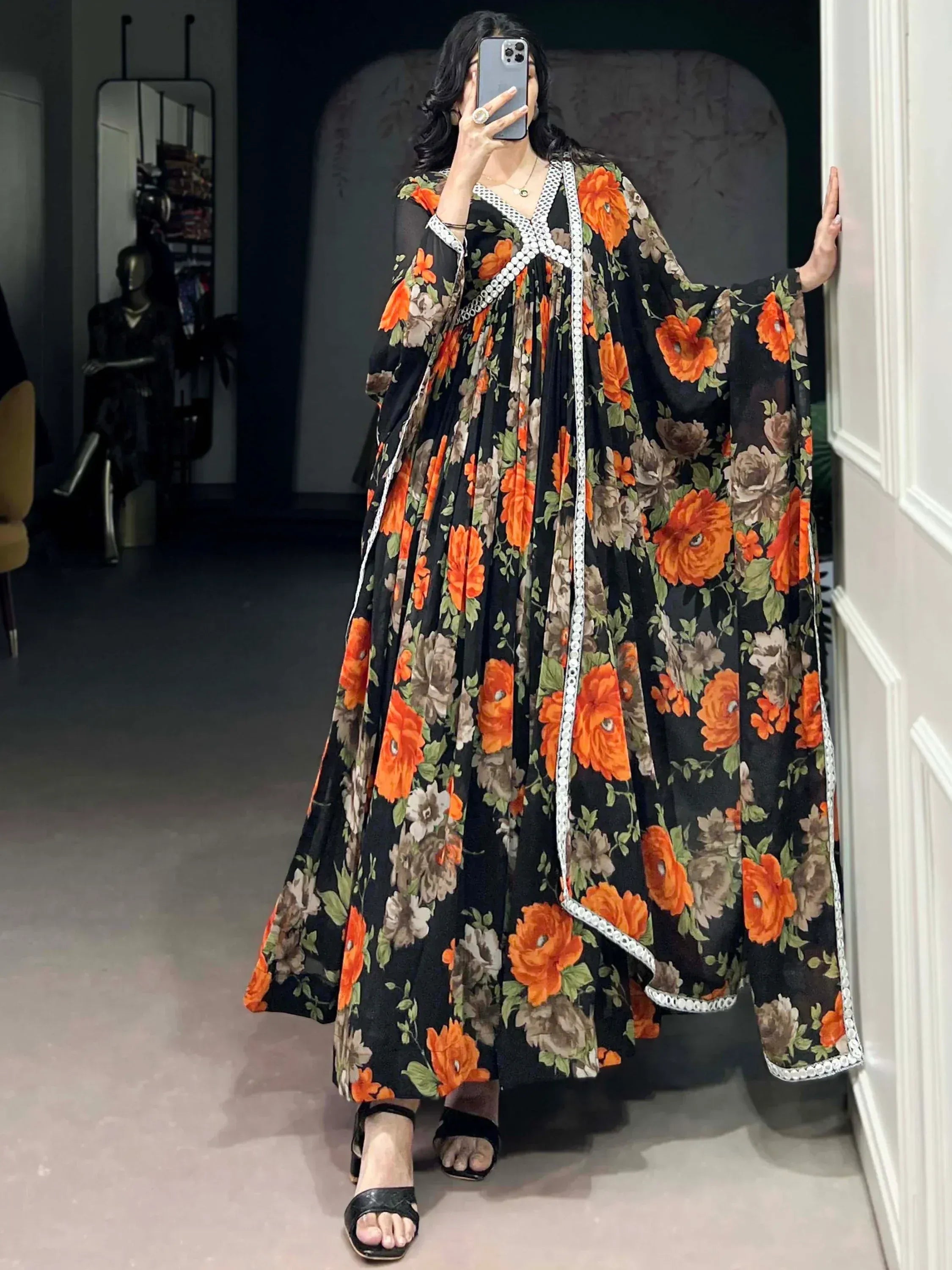 Black floral ethnic gown with orange roses and white trim, perfect for Indian occasions