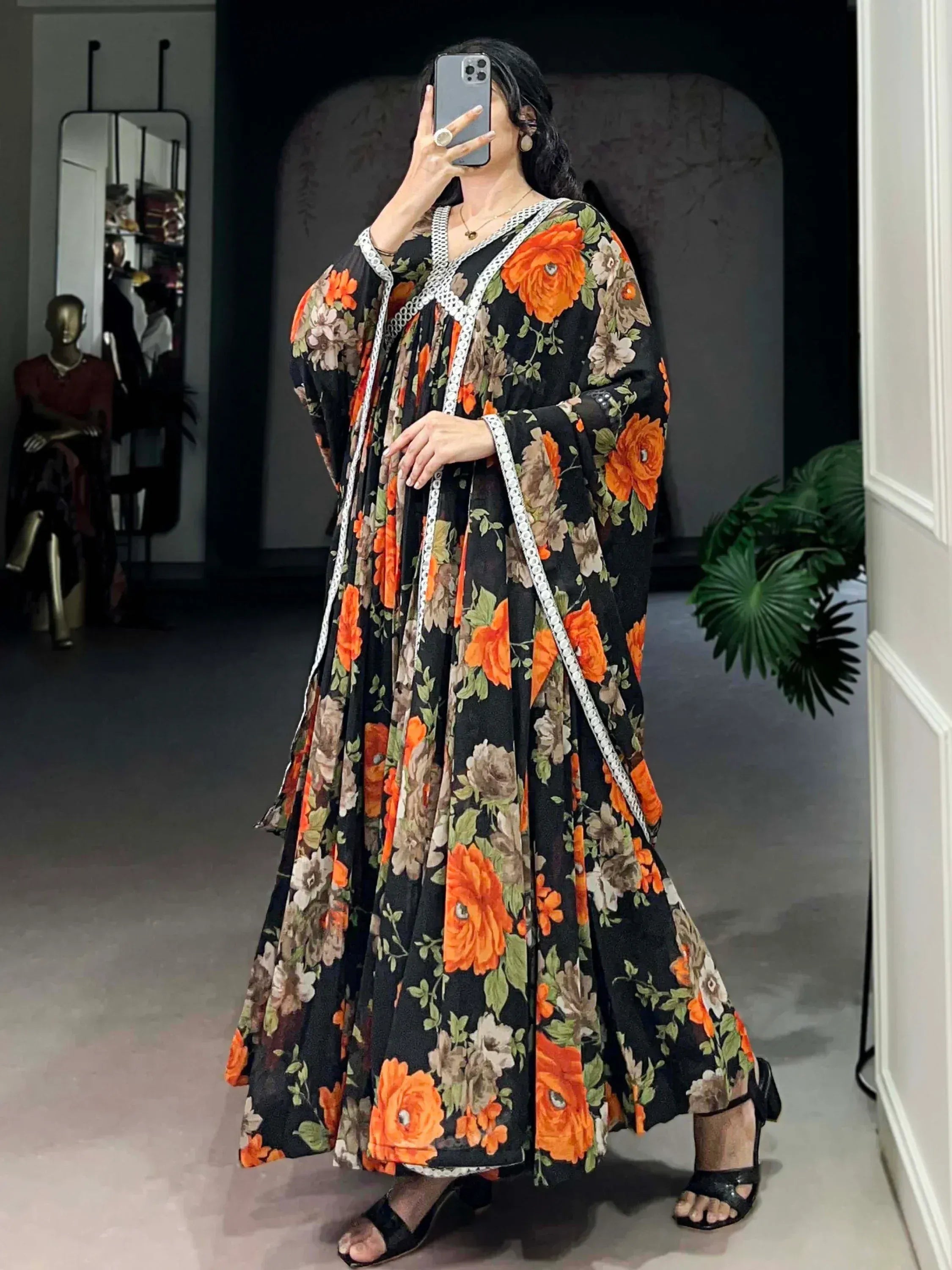Black floral ethnic gown with orange roses and white trim, perfect for Indian occasions