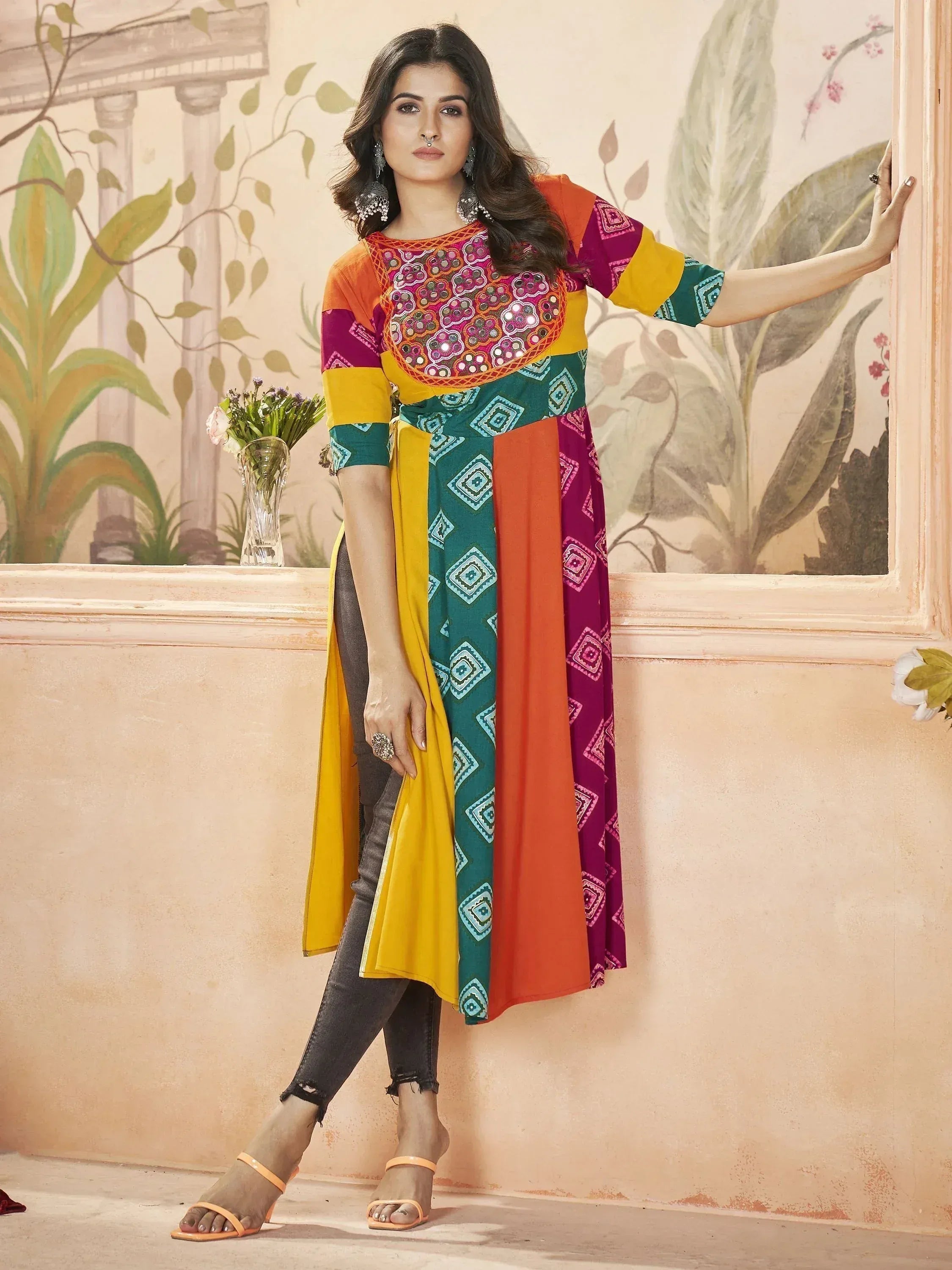 Colorful ethnic kurti with mirror work and geometric prints, paired with jeans for casual wear