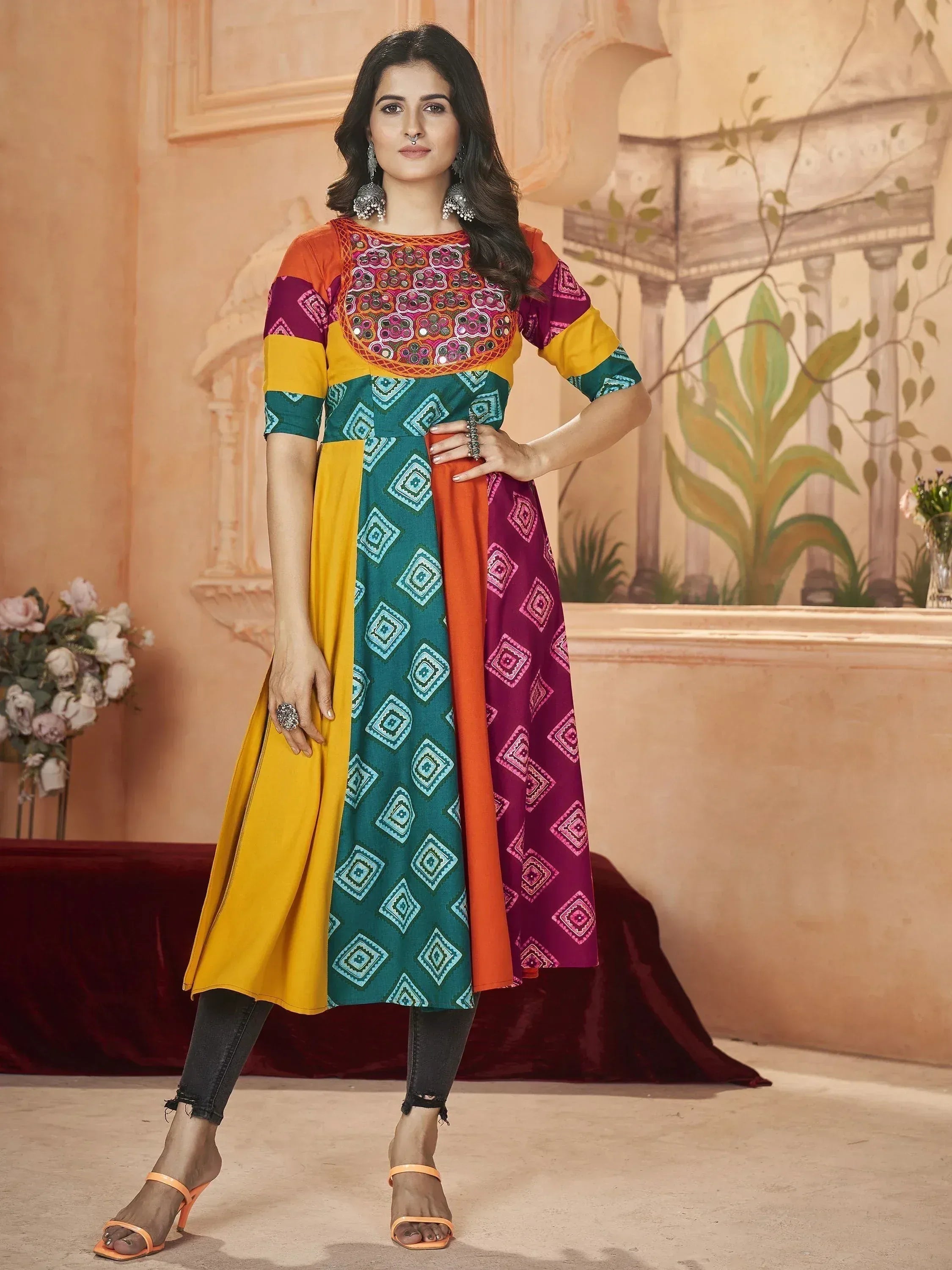 Colorful Indian ethnic kurti with mirror work, geometric prints, and patchwork design, paired with jeans