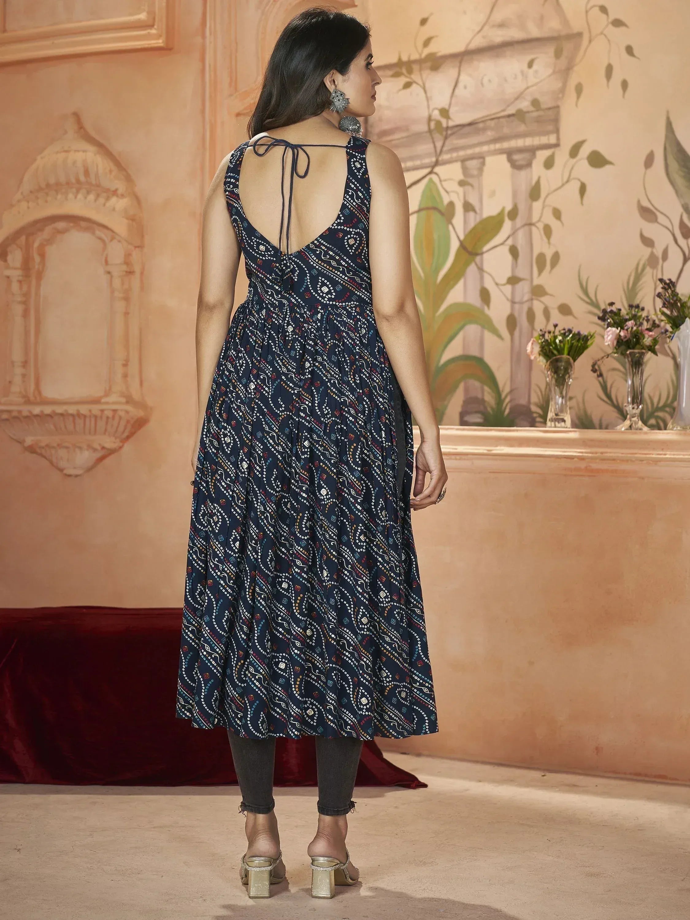 Navy blue printed ethnic gown with back tie detail, styled with jeans and heels for a modern fusion look.