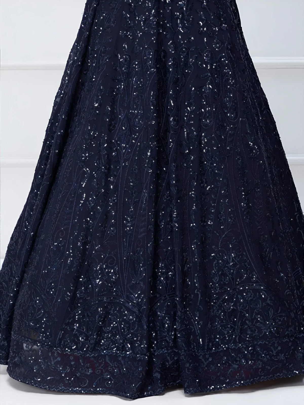 Navy blue sequin-embellished lehenga skirt with intricate floral embroidery, perfect for Indian ethnic wear.