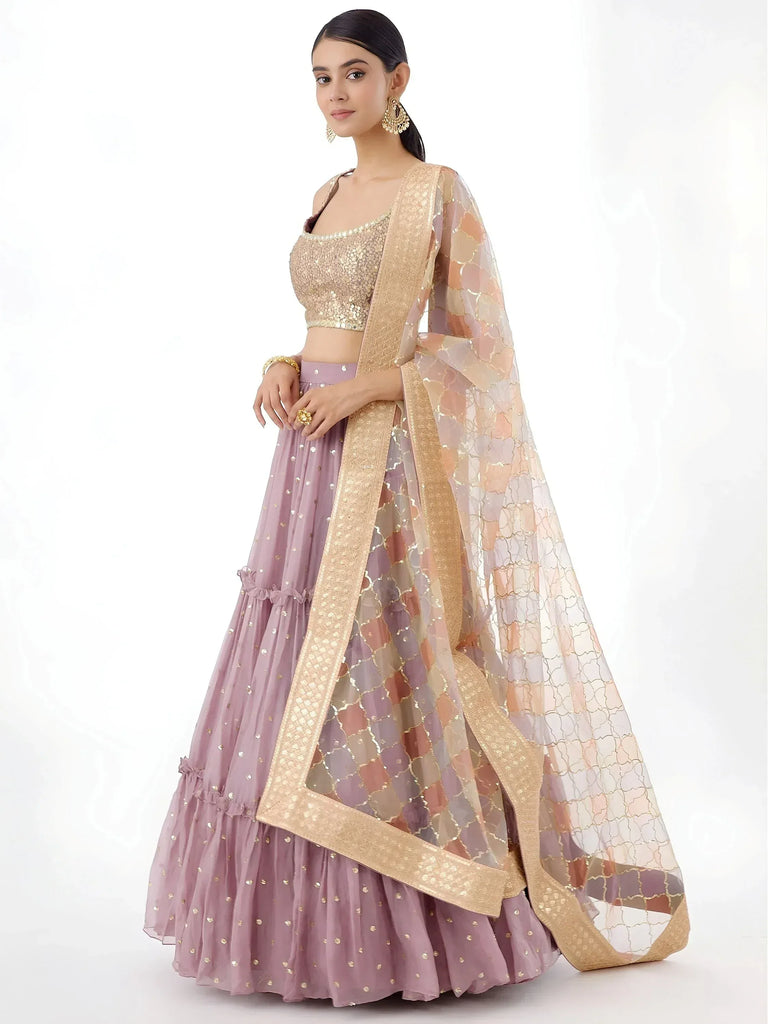 Elegant lavender lehenga choli with gold sequins and sheer dupatta, perfect for Indian ethnic occasions